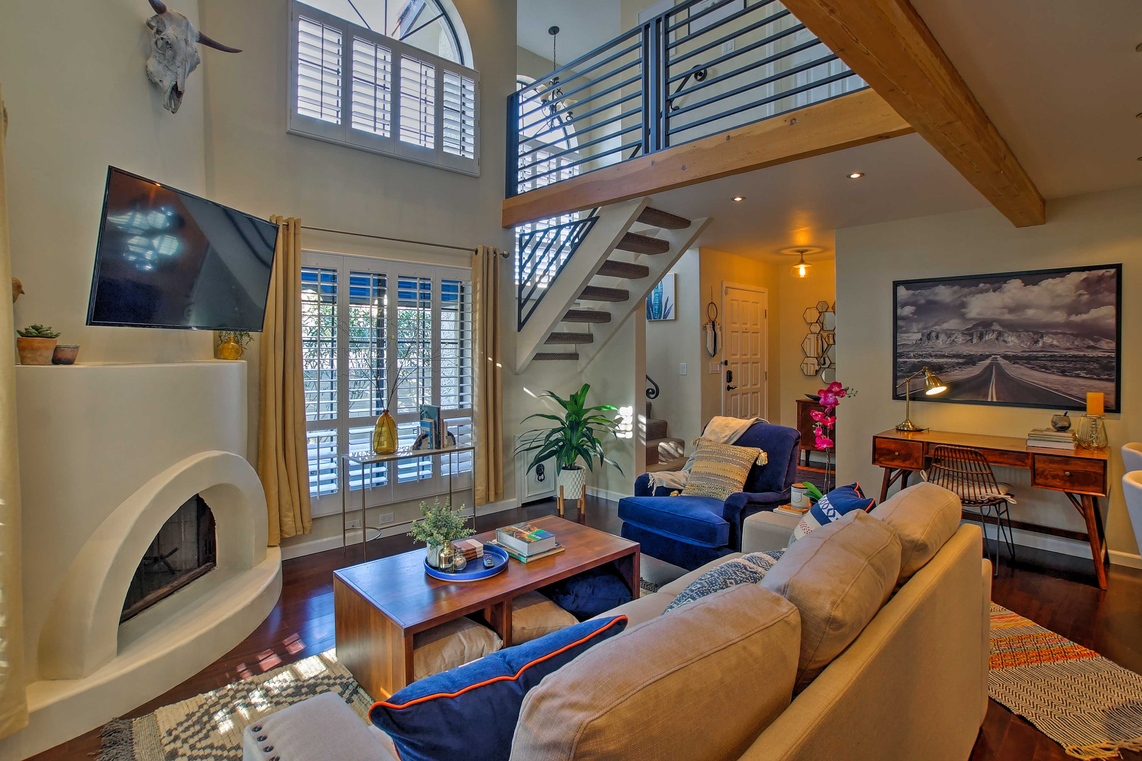 Relax in front of the adobe gas fireplace and towering two-story wall.