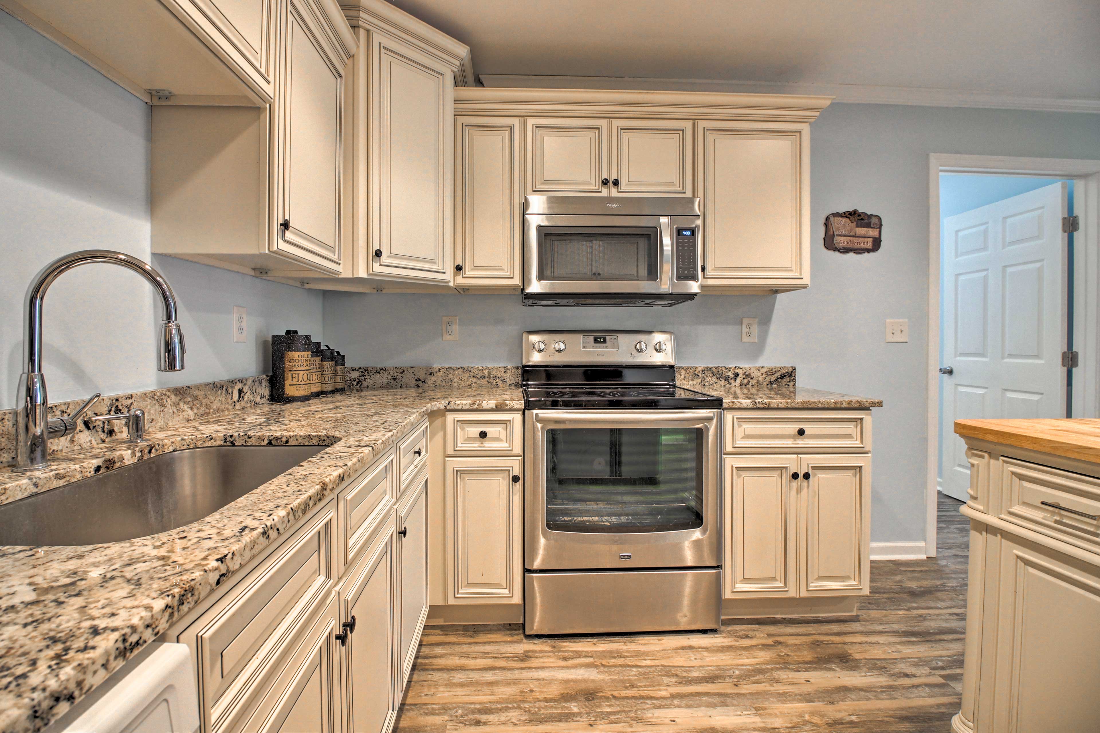 The kitchen boasts stainless steel appliances and granite countertops.