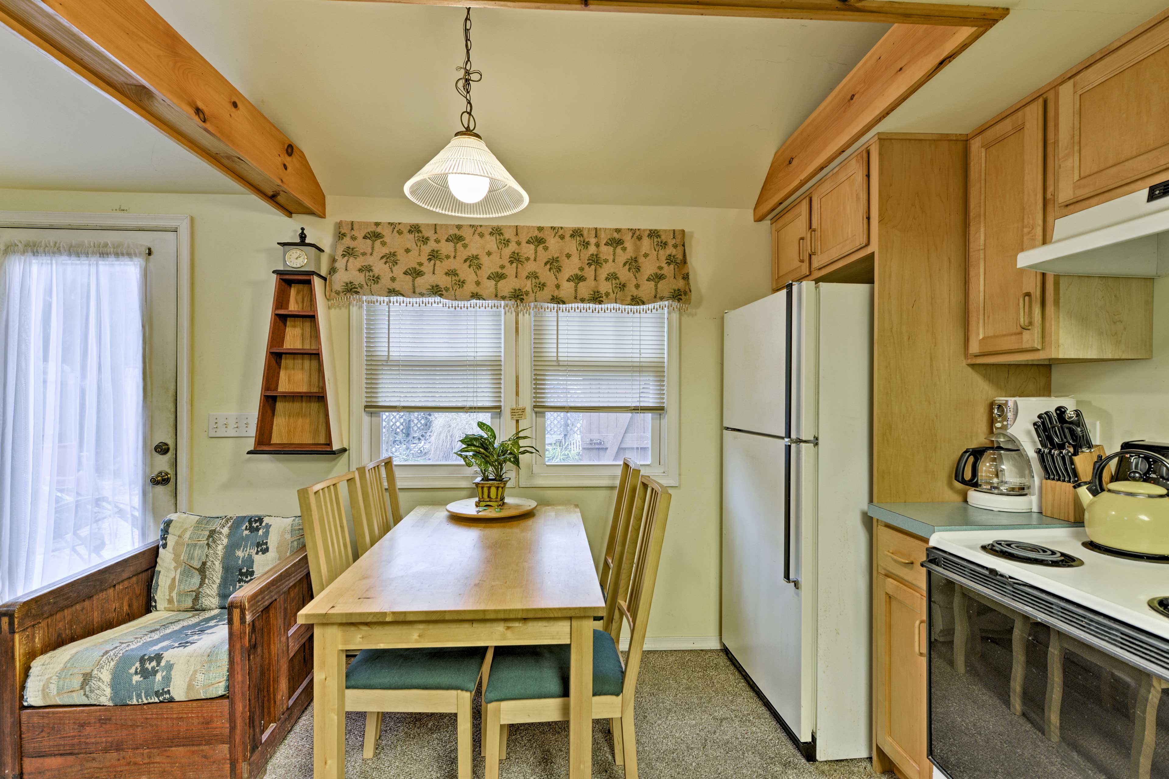 Dine indoors around the 4-person wooden table.