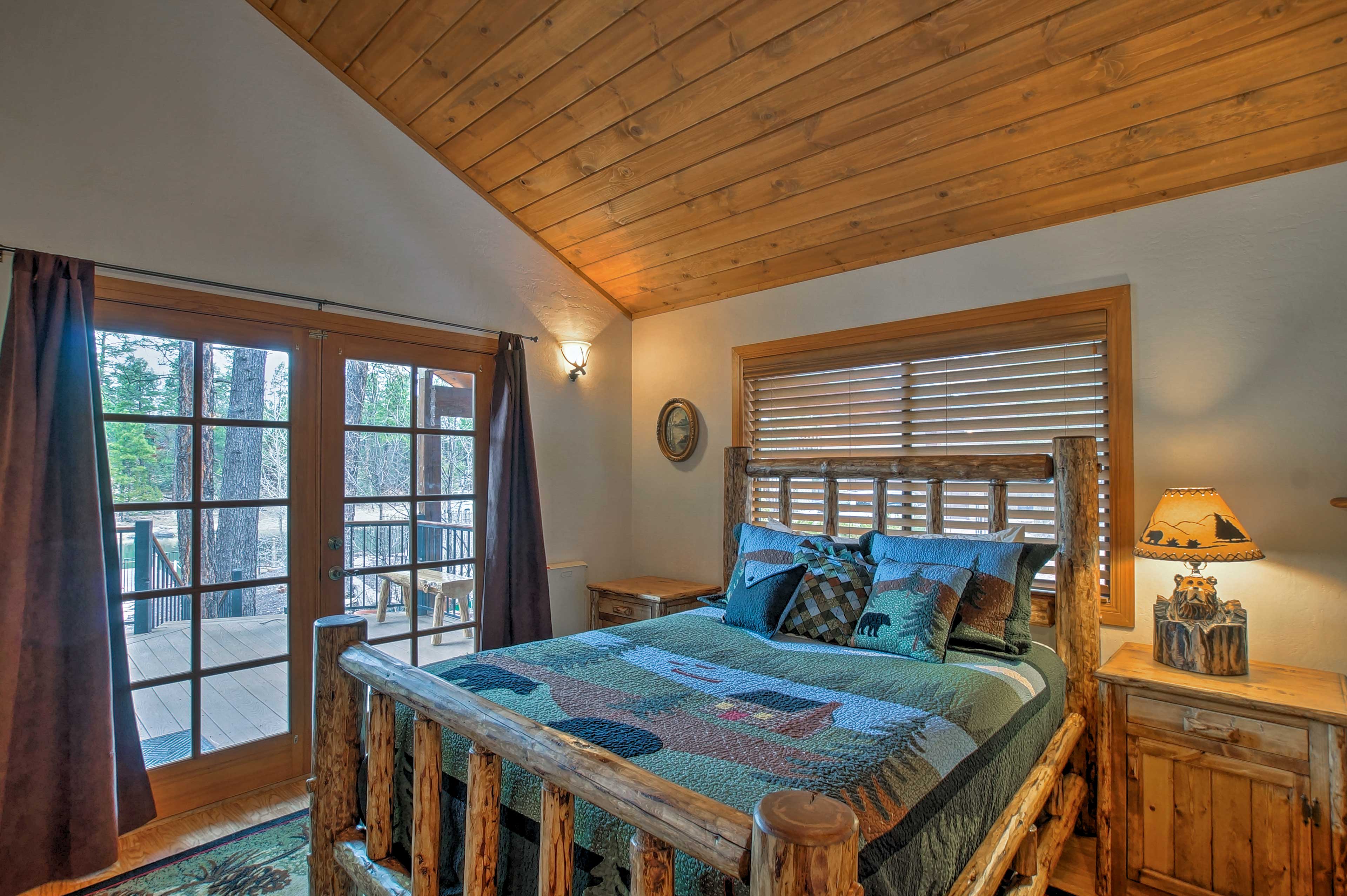 This first bedroom includes a queen bed and french doors to access the patio.