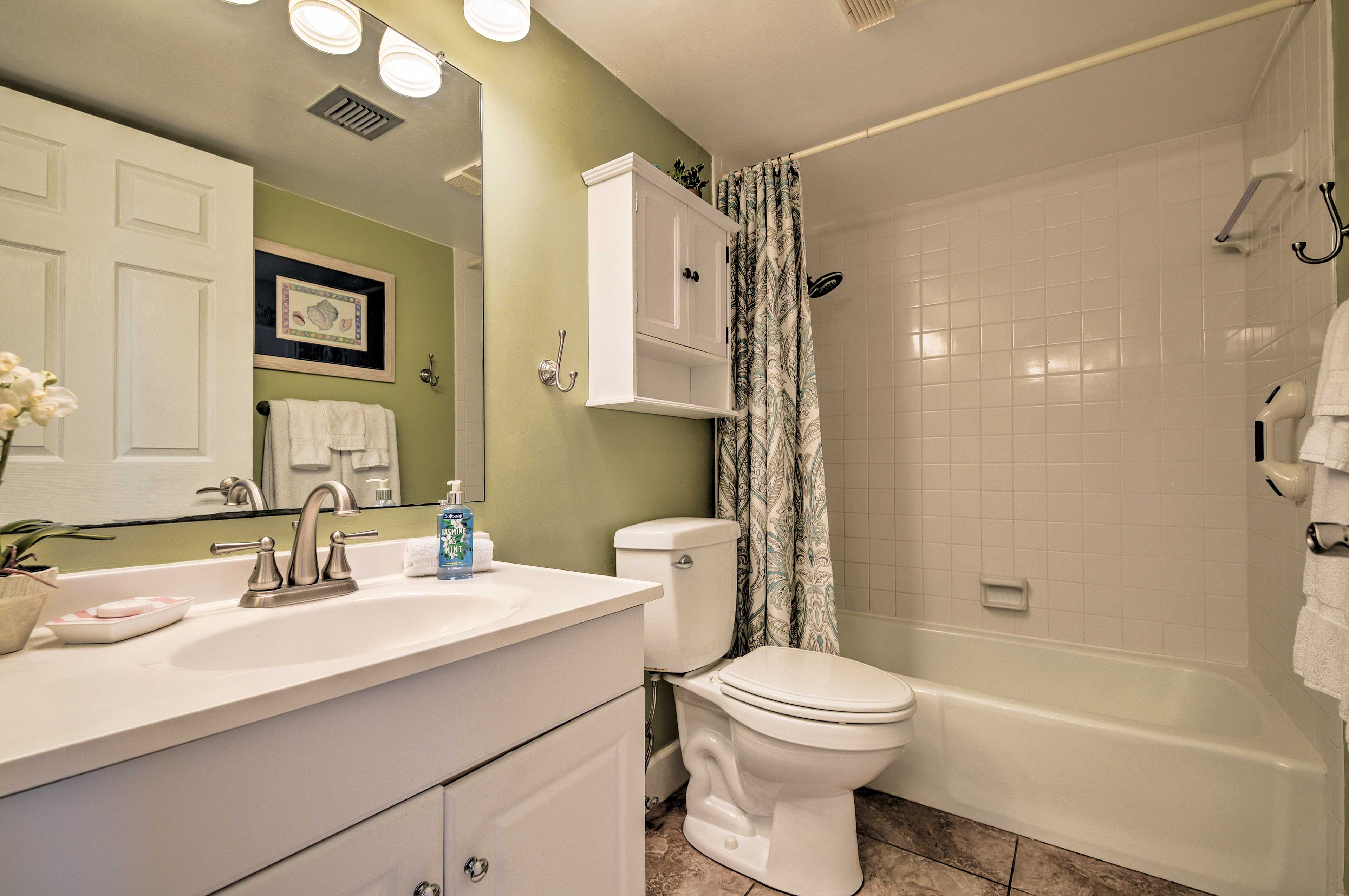 The private en-suite bathroom features handicap friendly handrails.