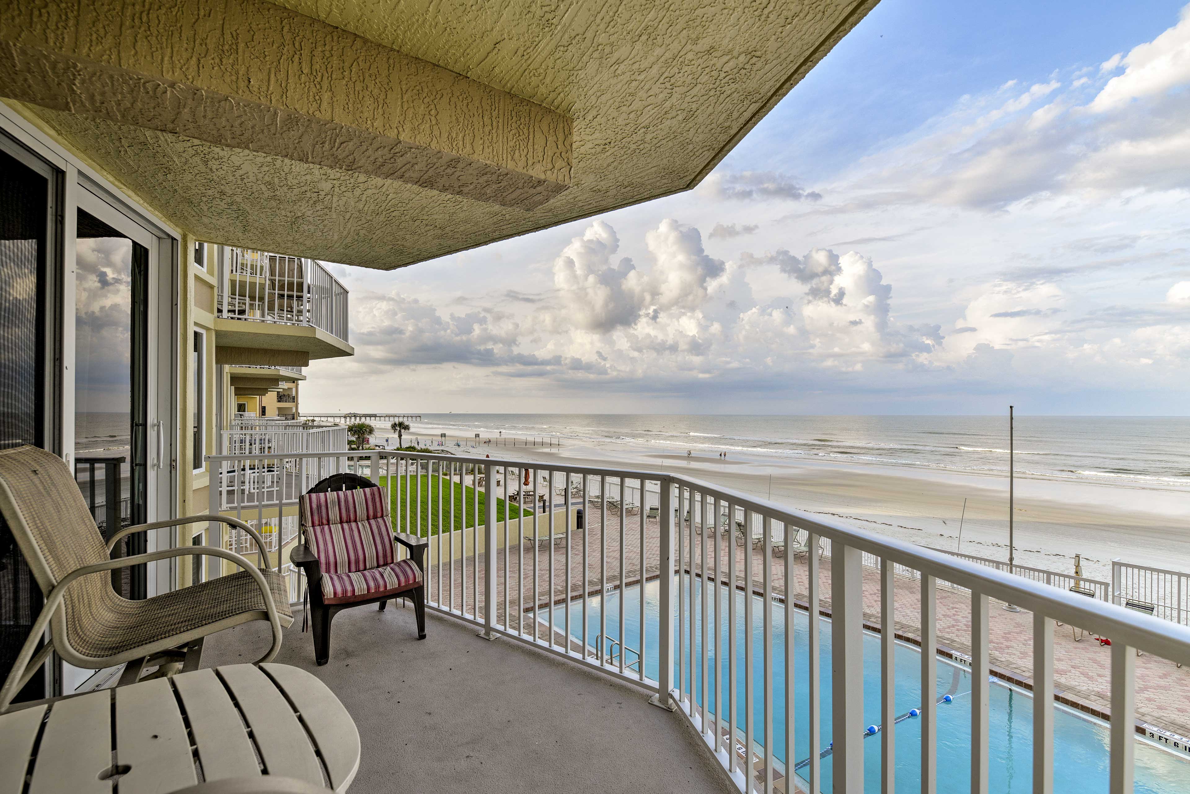 Step outside to the balcony to admire the pool and water views.