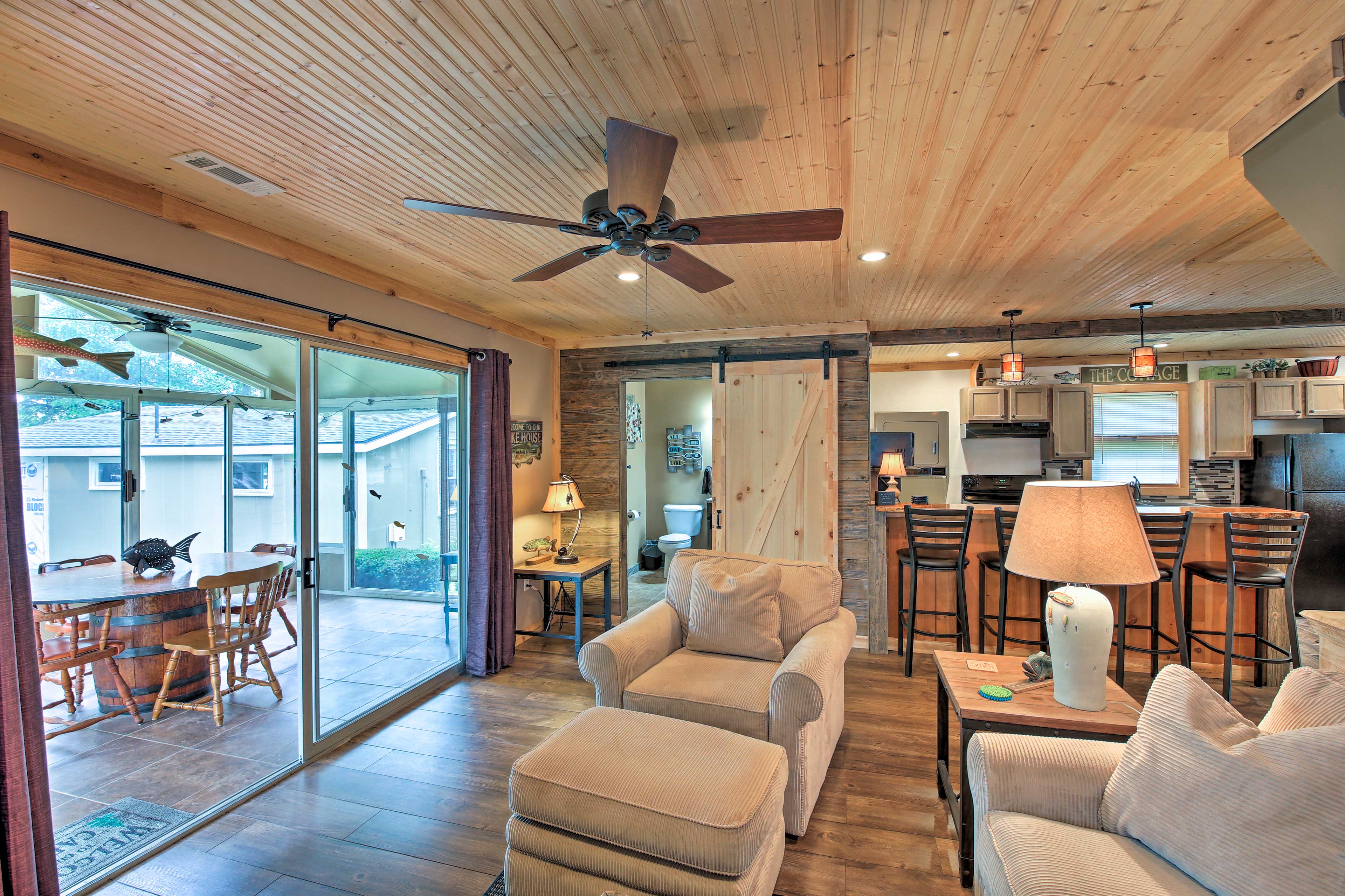 The living room hosts a flat-screen cable TV and direct access to the sunporch.