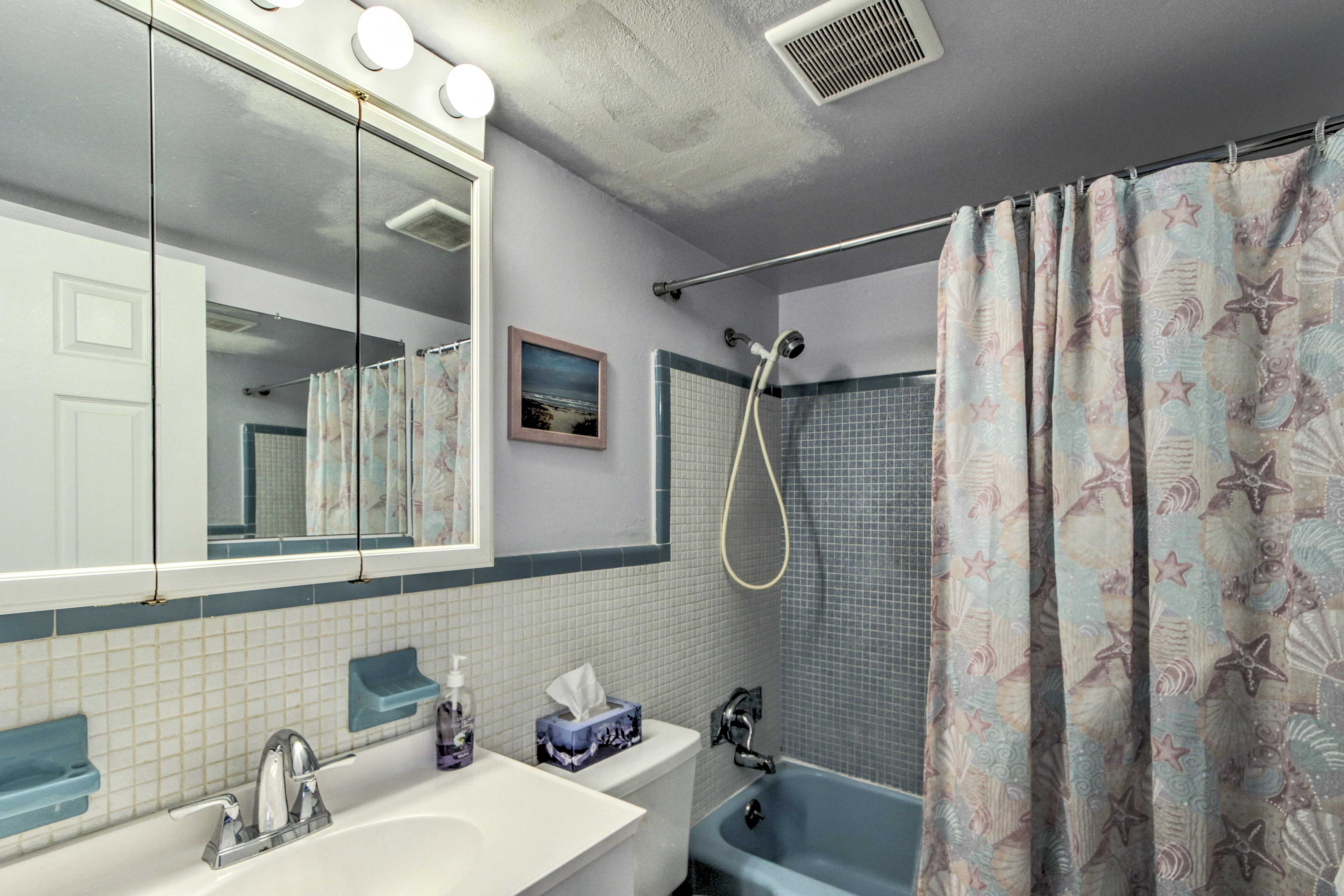 The full bathroom has a single sink, small vanity, and a shower/tub combo.