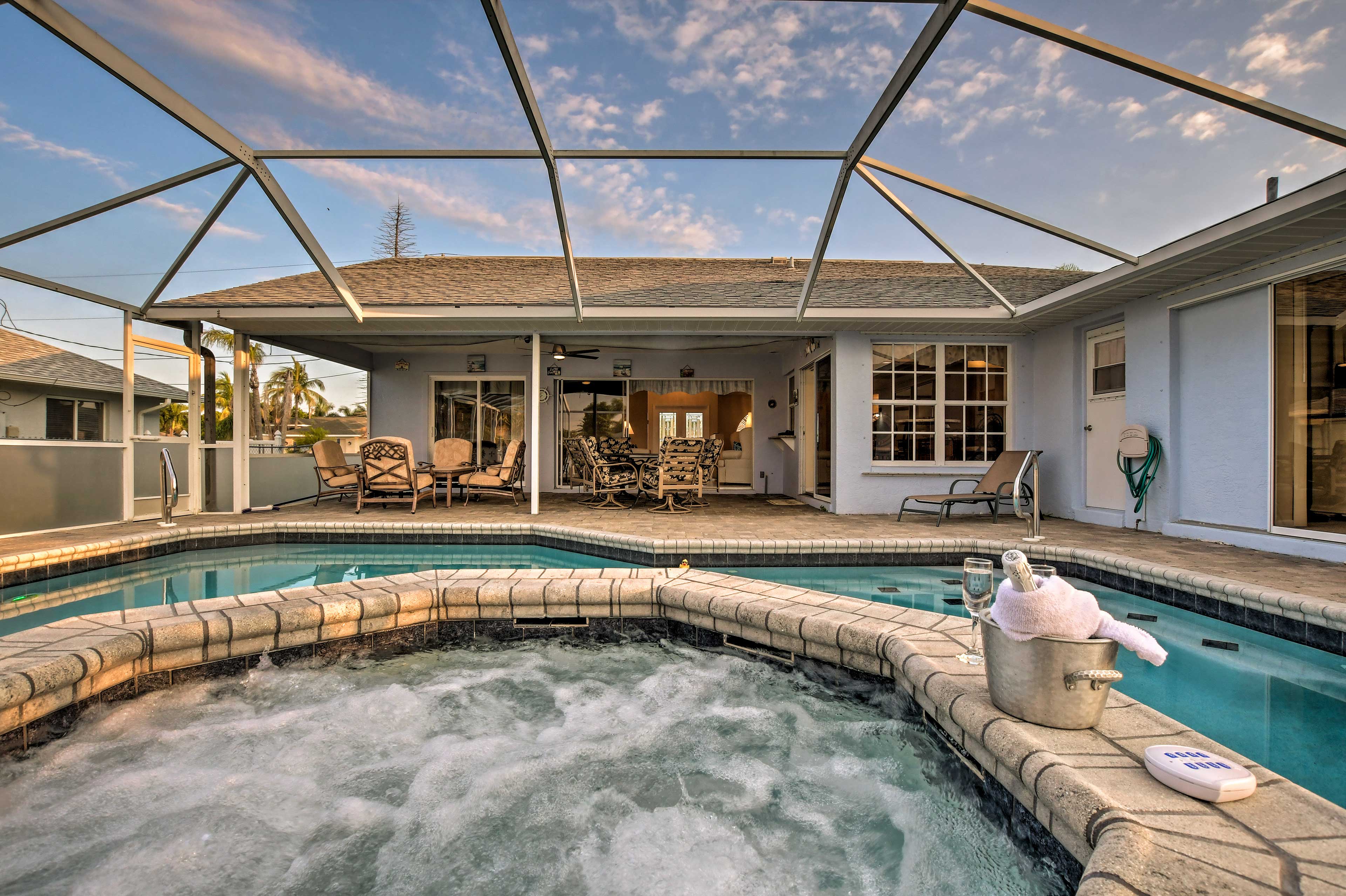 The screened-in lanai lets in the views of clear blue skies and puffy clouds.