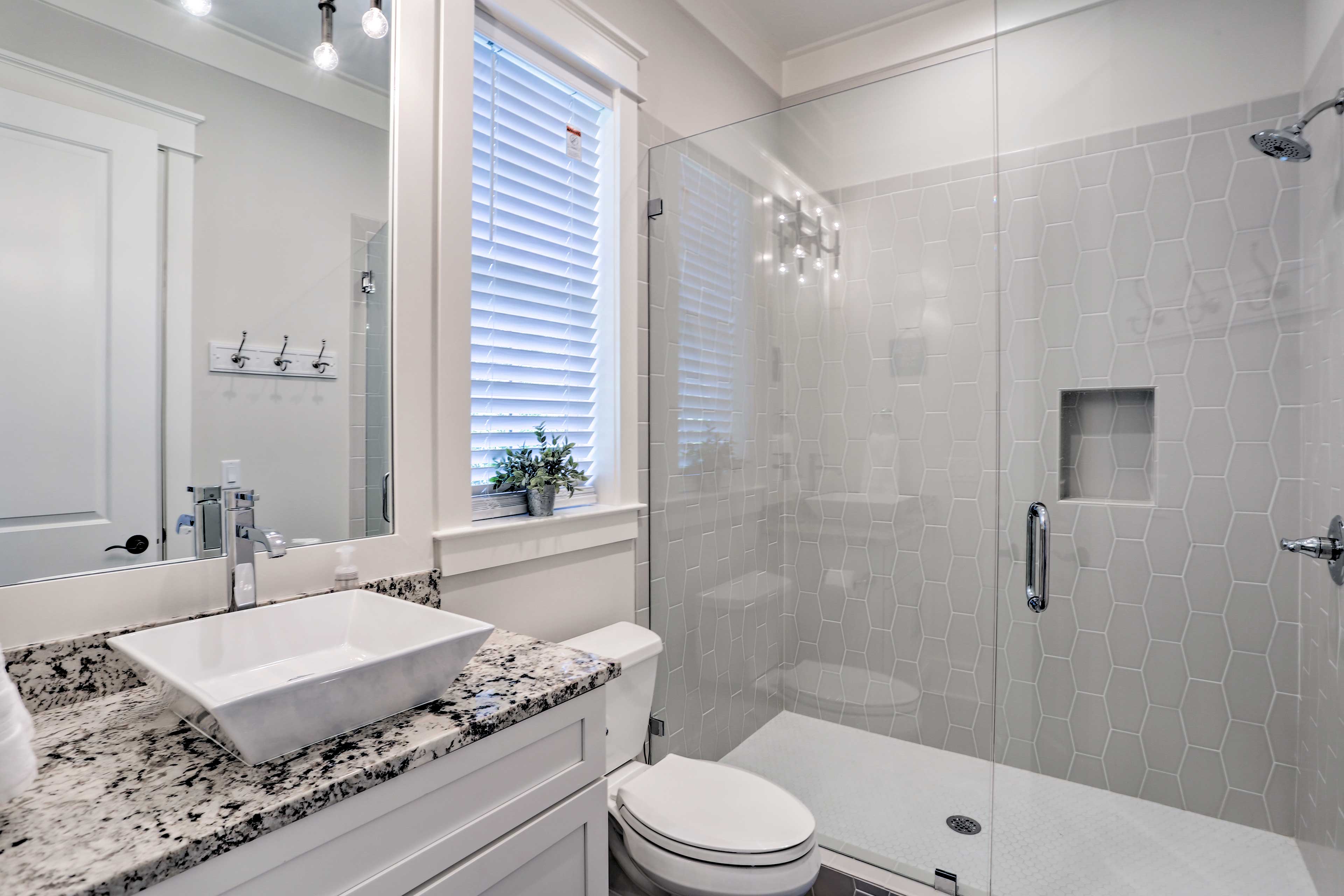 The luxuries of this modern, full bathroom with walk-in shower are in your room!