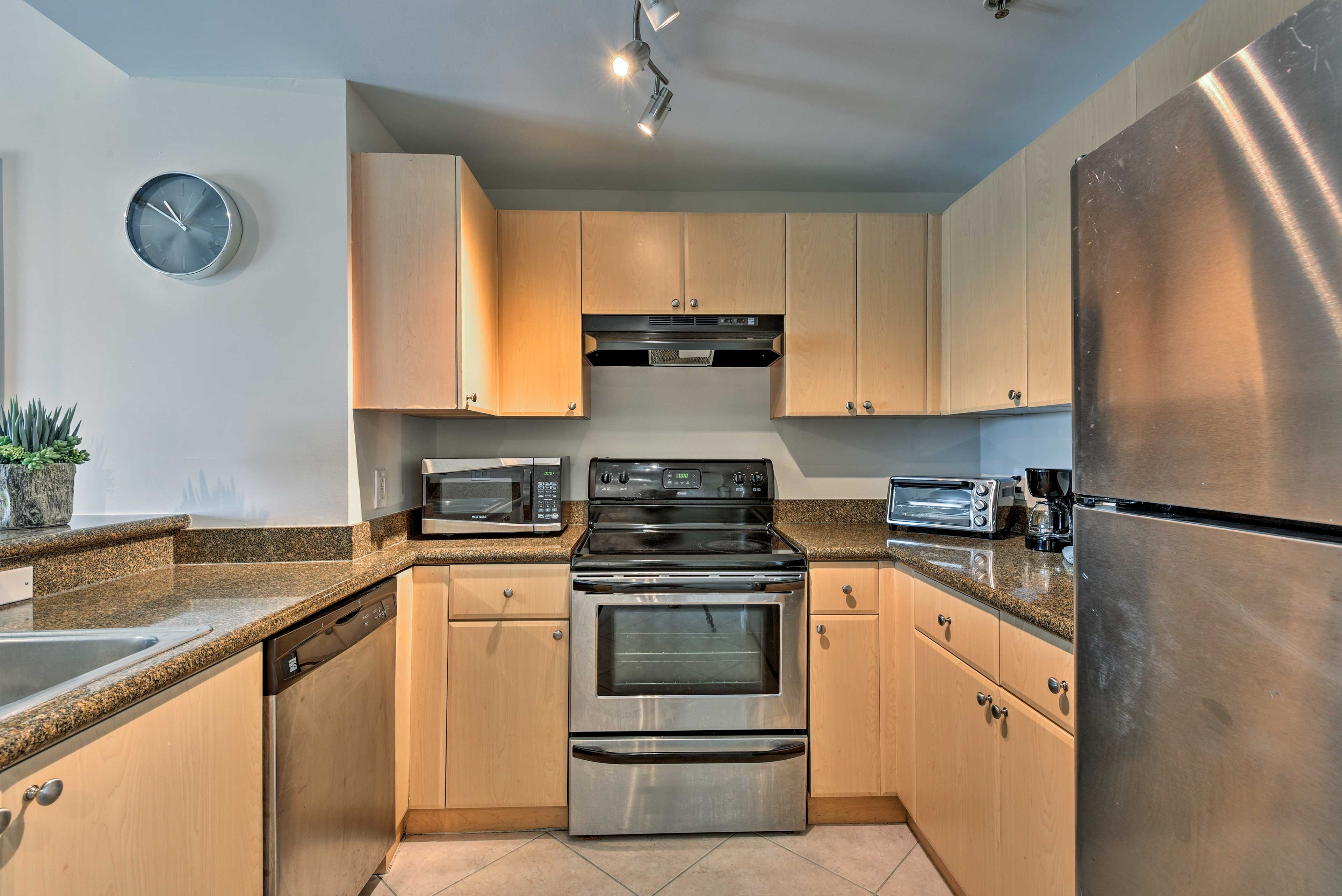 The fully equipped kitchen features stainless steel appliances.