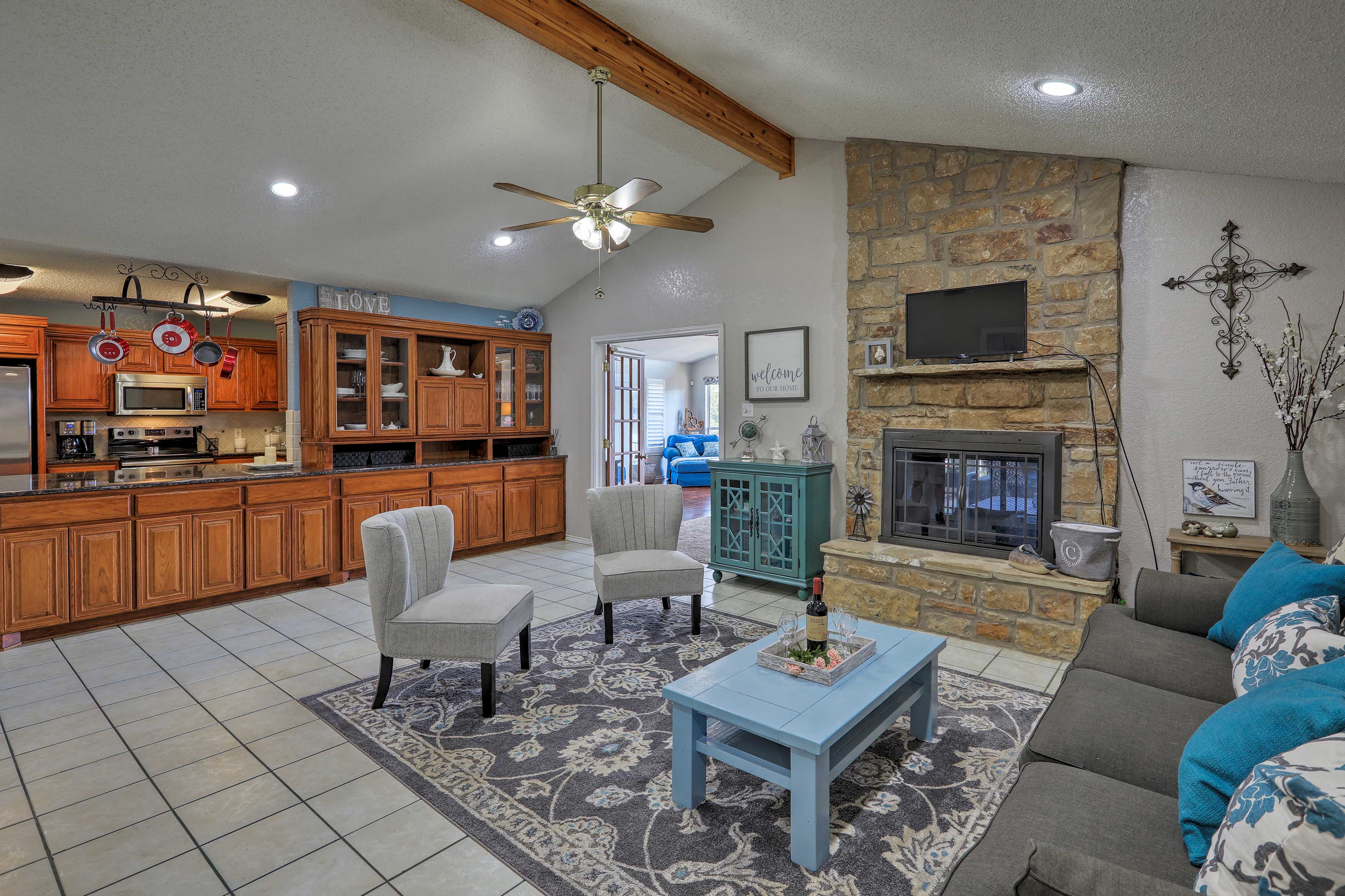 Living Room 2 | Exposed Wood Beams | 2-Sided Wood-Burning Fireplace | Main Level