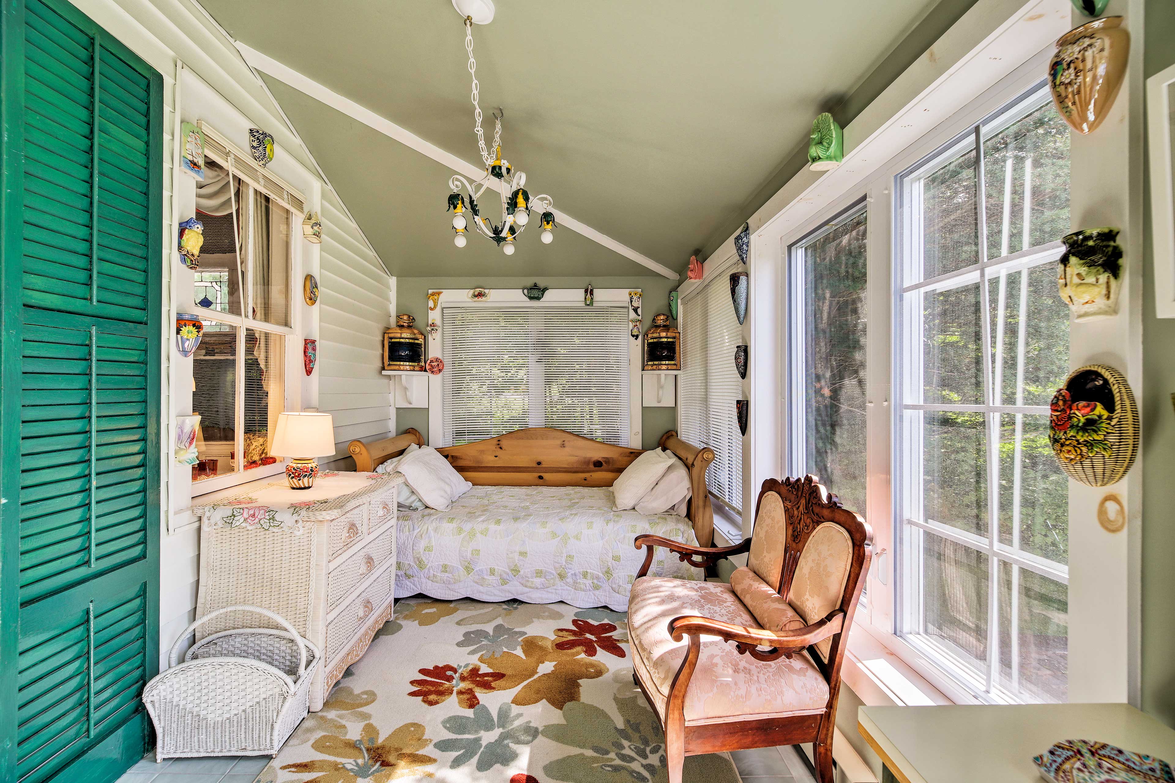 Additional sleeping arrangements can be made on the sun porch's twin daybed.