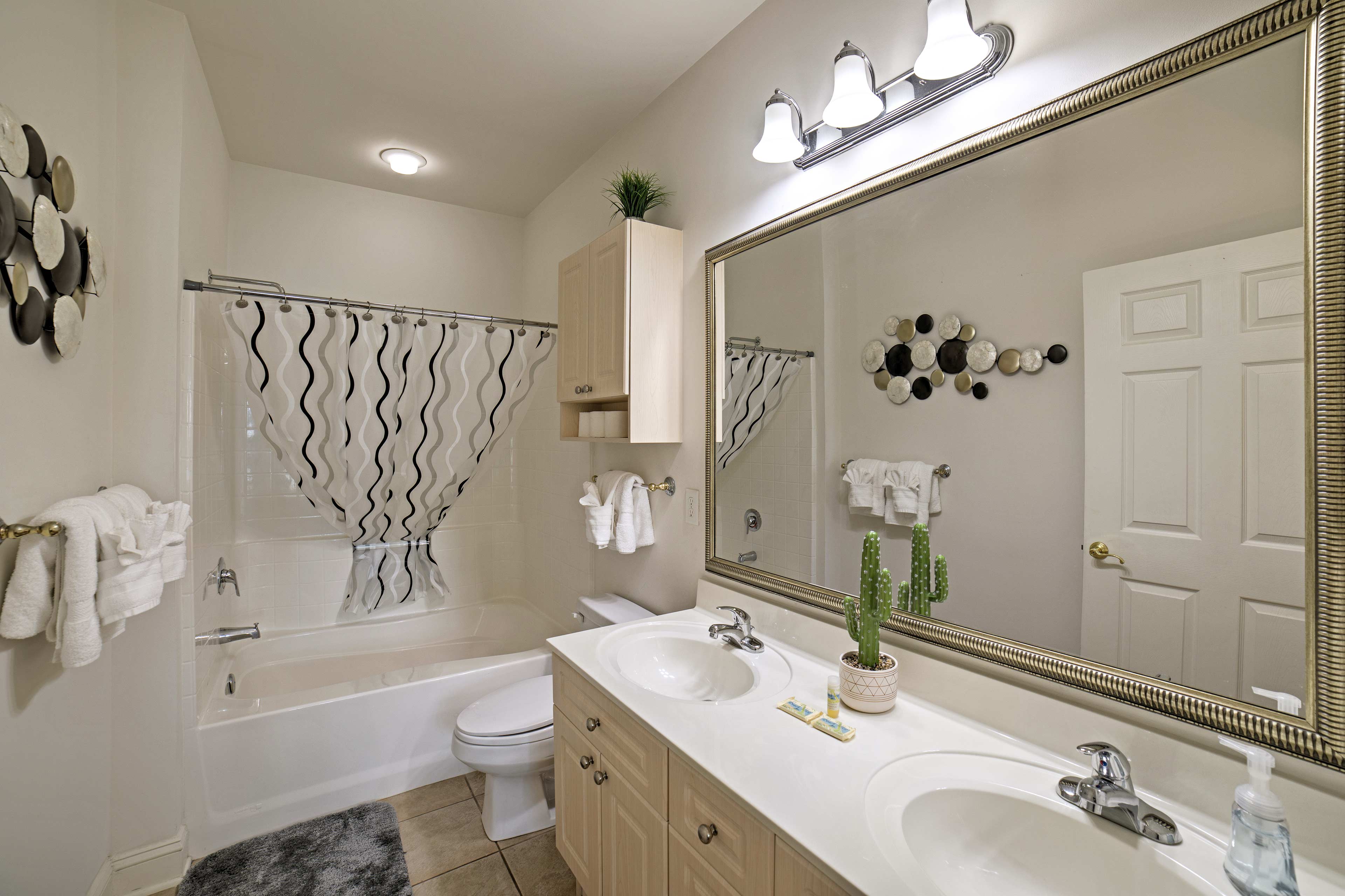 Your en-suite bathroom houses a double vanity and shower/tub combo.