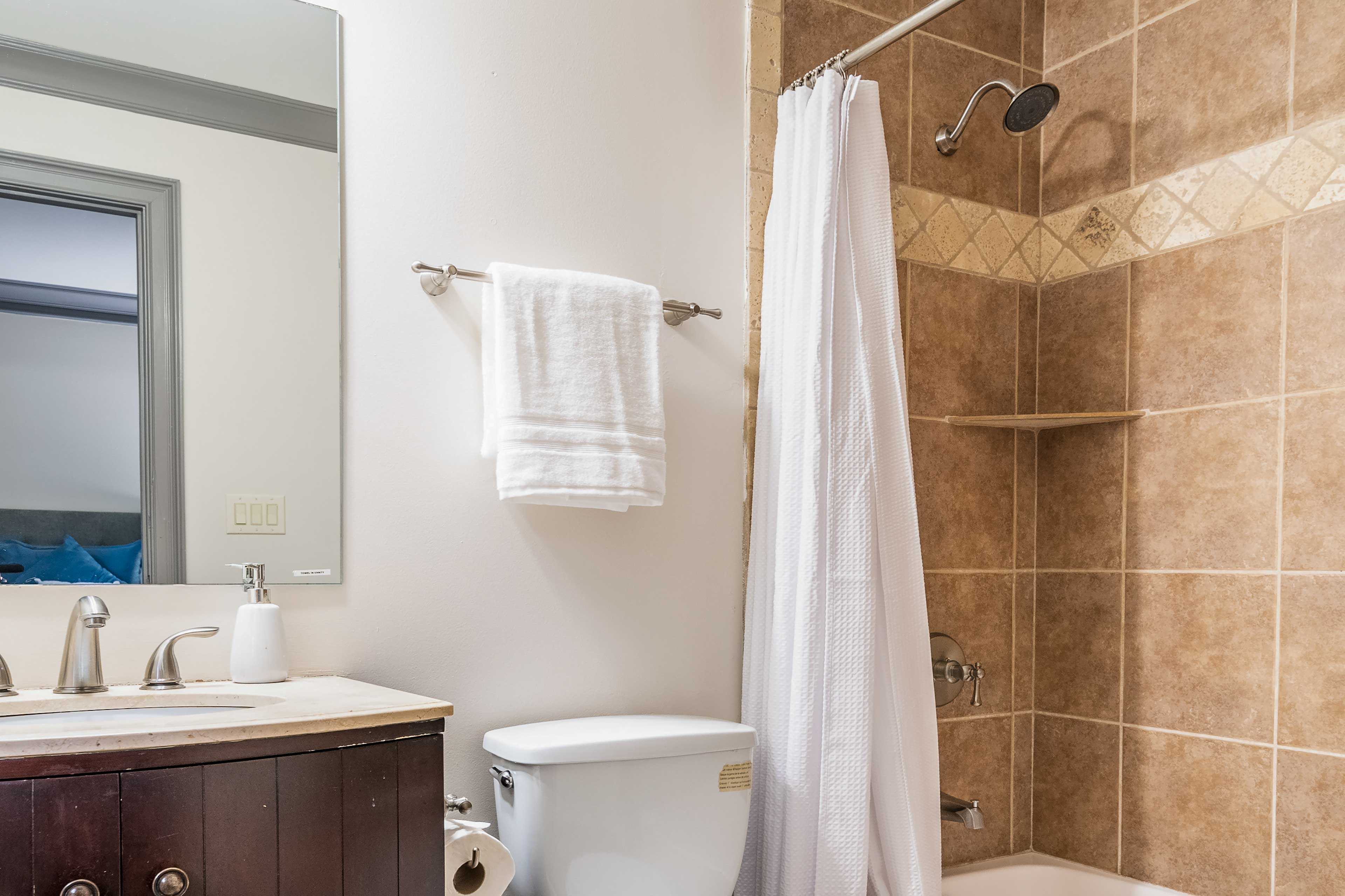 Get ready for a night out in the shower/tub combo of this bathroom.