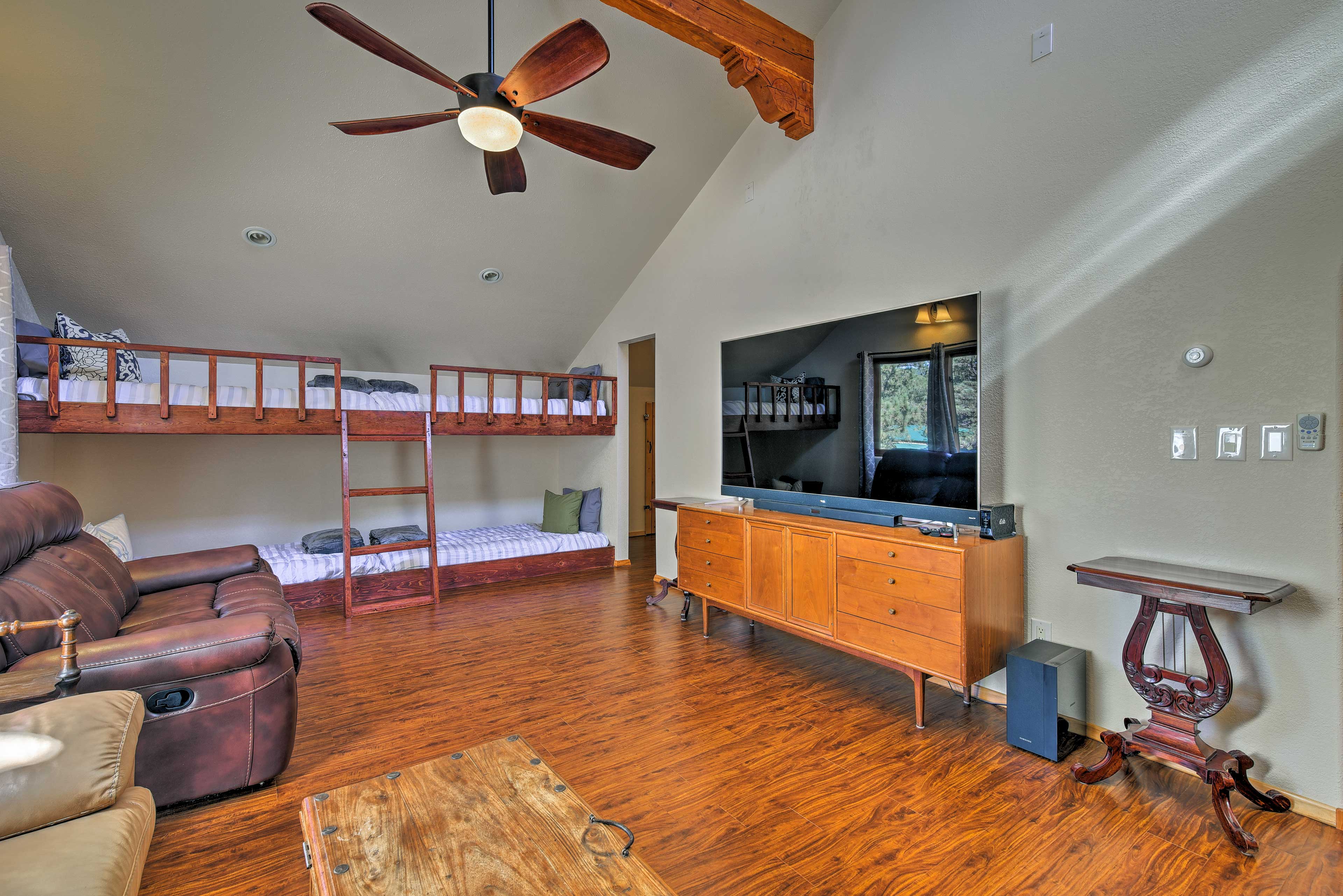 Doubling as a media room, this bedroom hosts 4 built-in twin bunk beds.