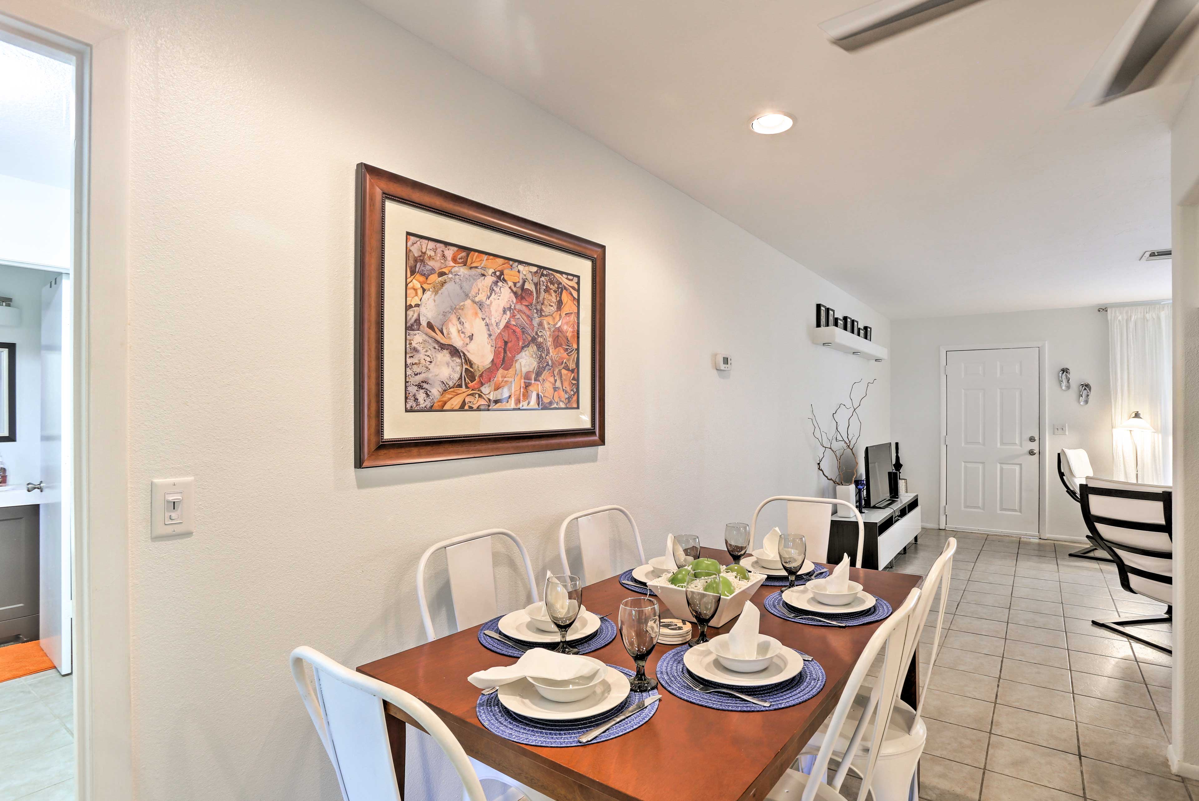 The dining table is situated in between the living area & kitchen.