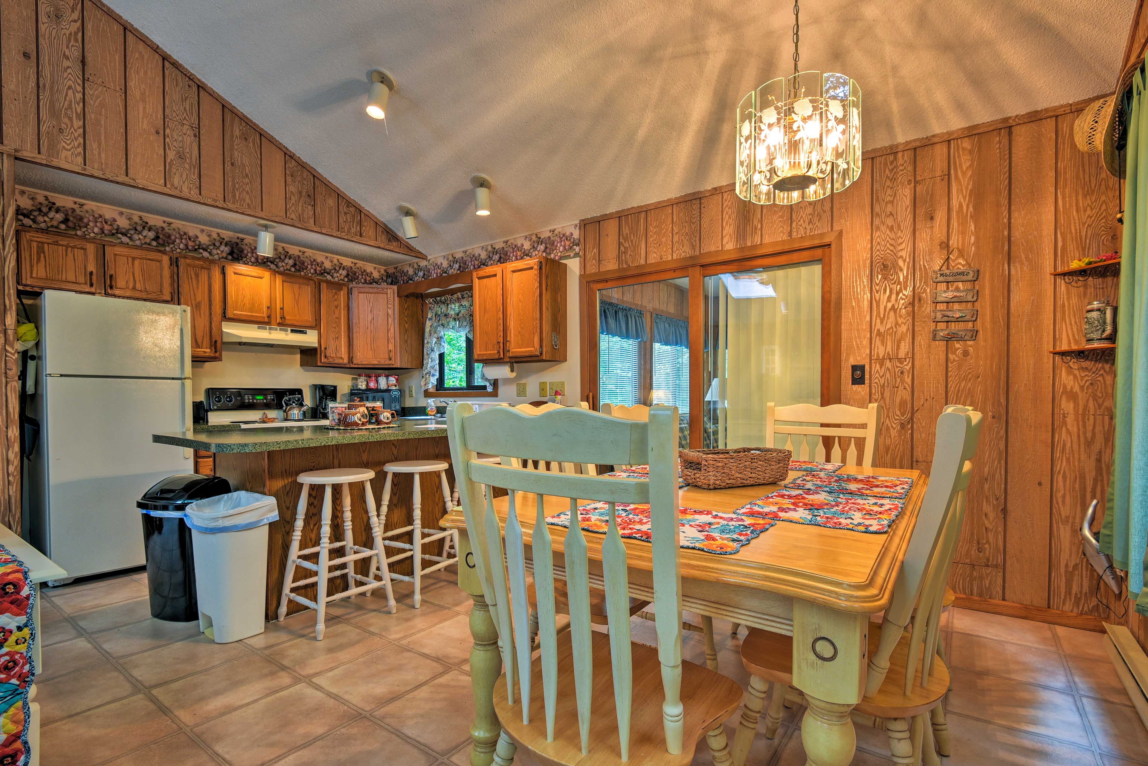 The cabin features traditional log paneling & rustic furnishings.