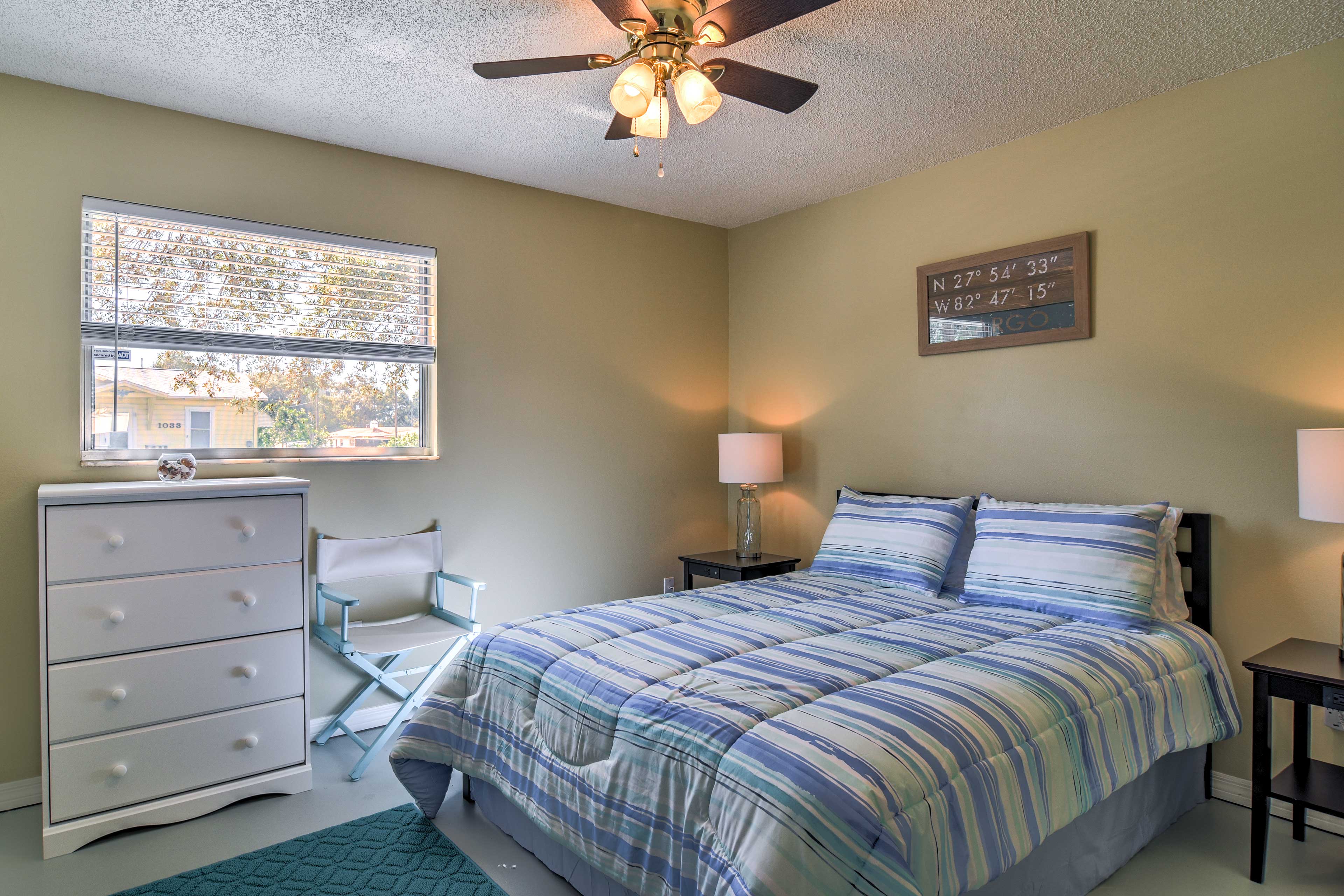 The first bedroom features a blue theme that promotes a beachy vibe!