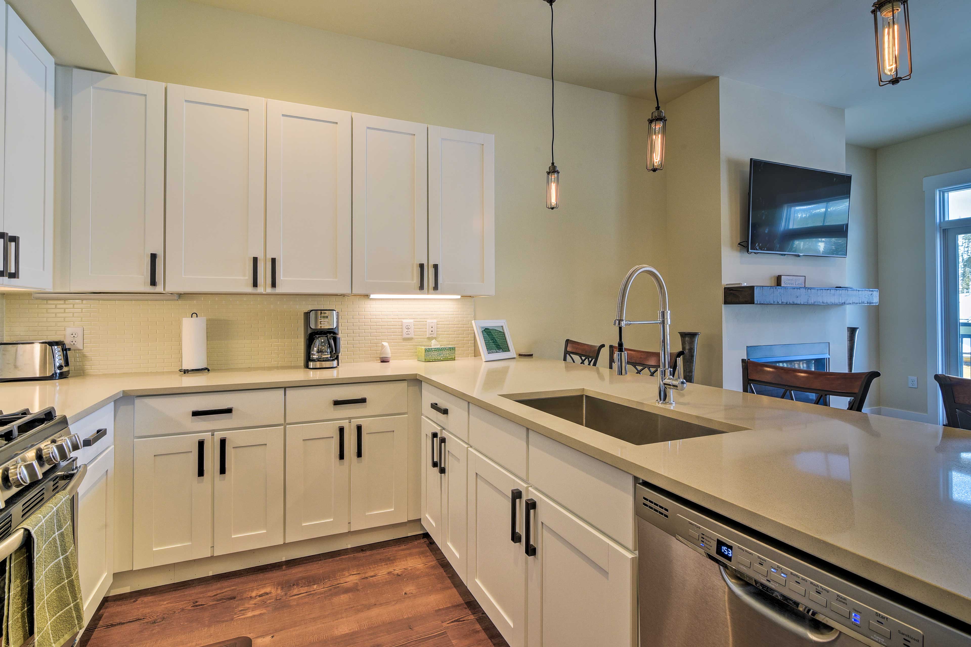 The kitchen features expansive countertops and a 4-person breakfast bar.