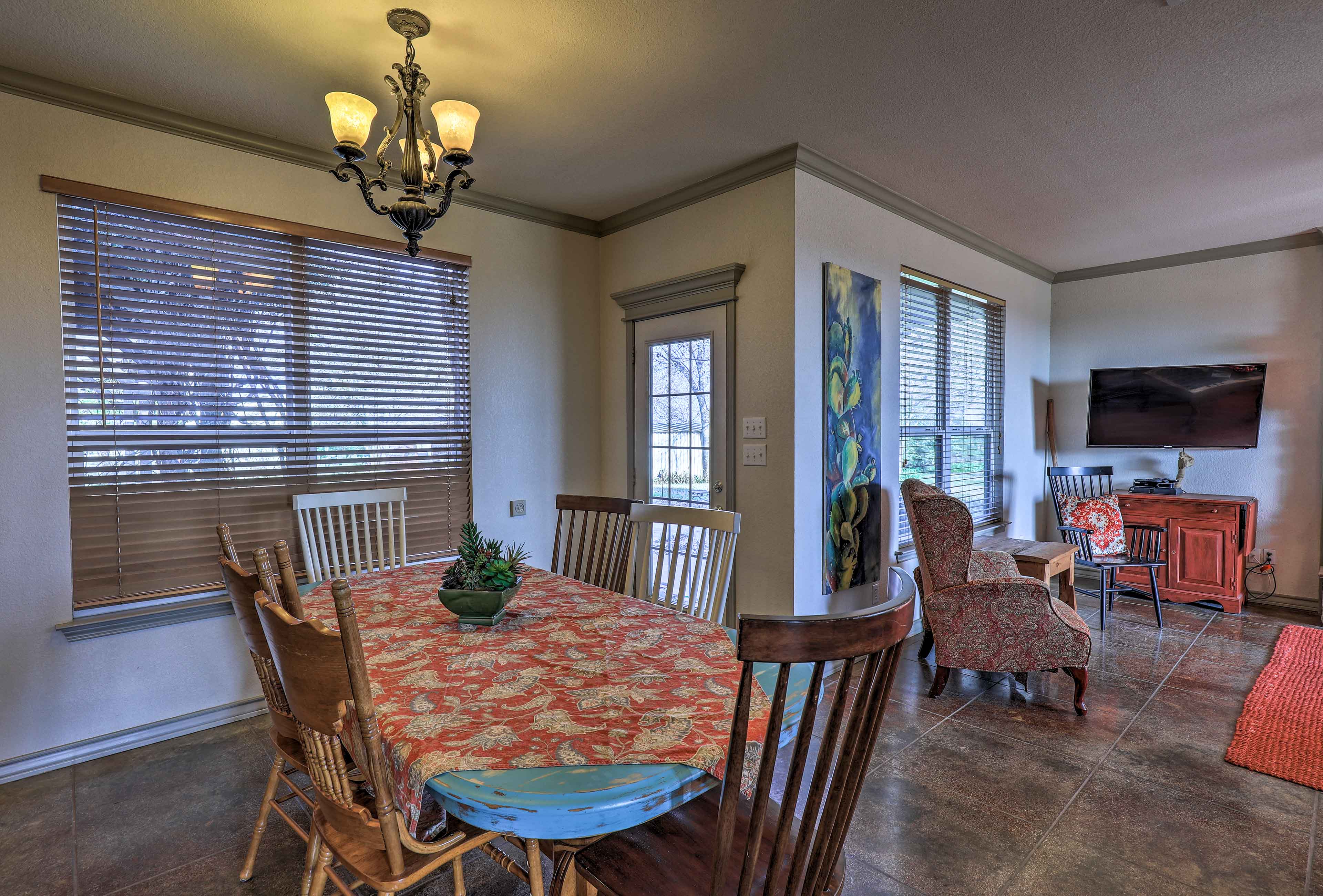 Dine family-style around the rustic 6-person dining table.