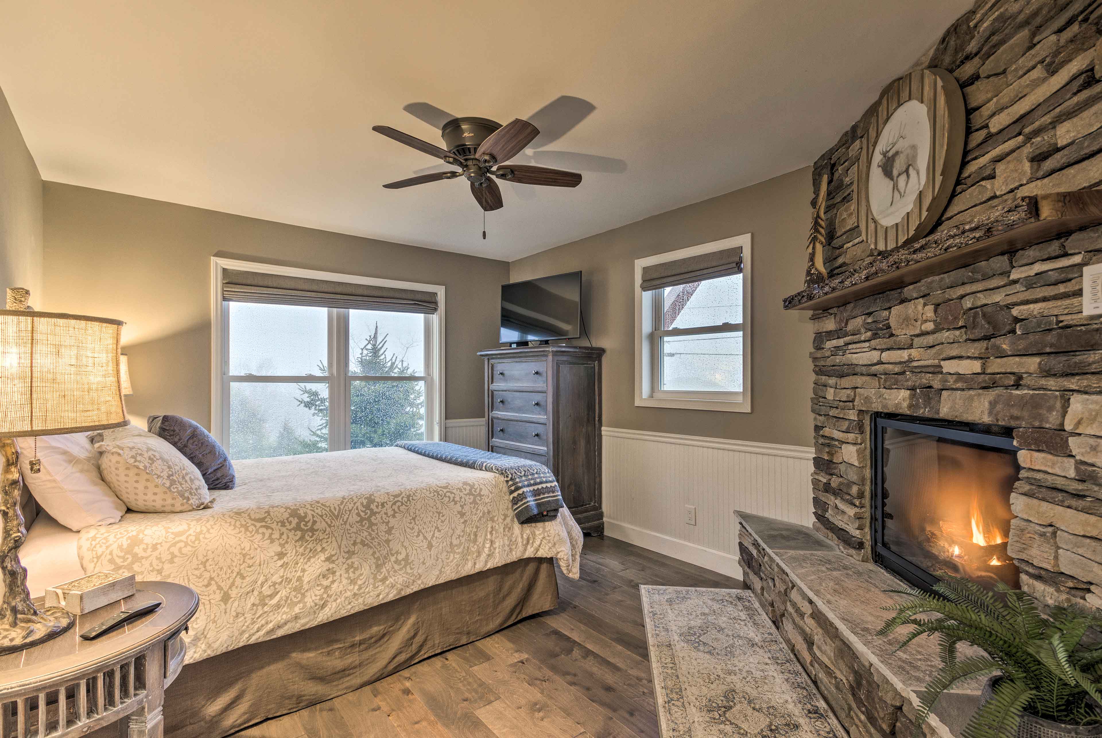 Curl up next to the gas fireplace in this main bedroom.