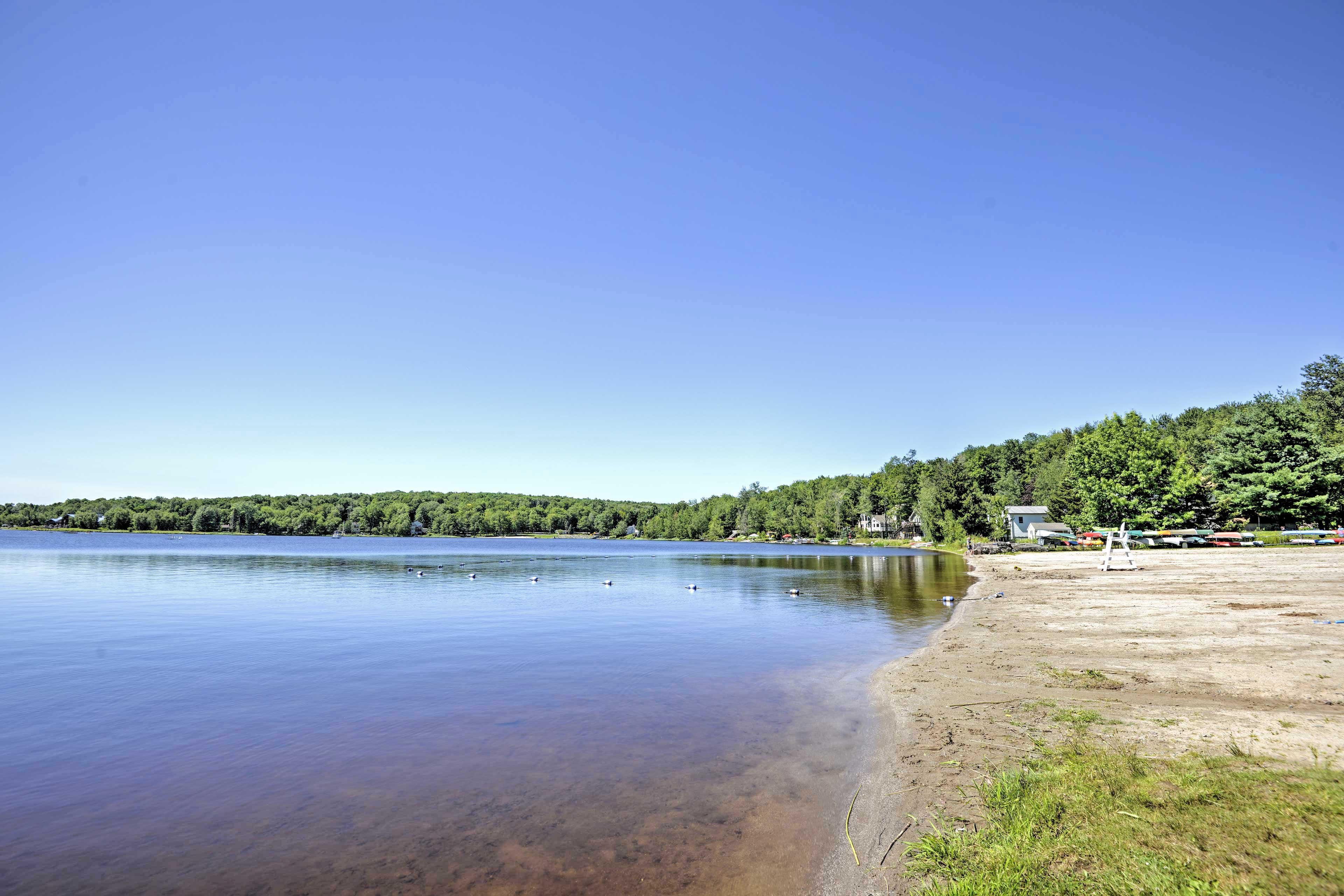 Sink your toes in the sand while gazing out at the stunning lake.
