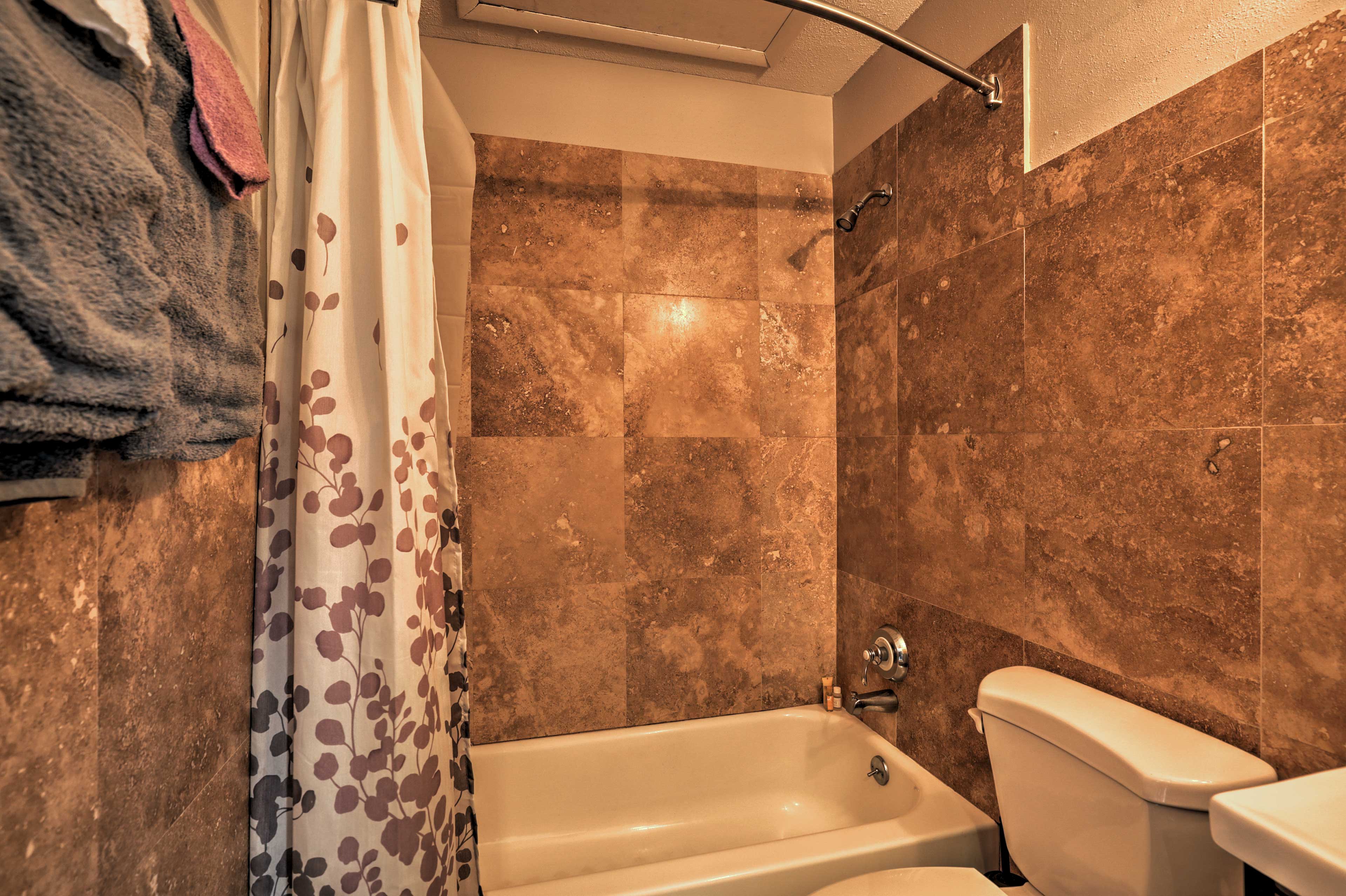 The bathroom offers a shower/tub combo.