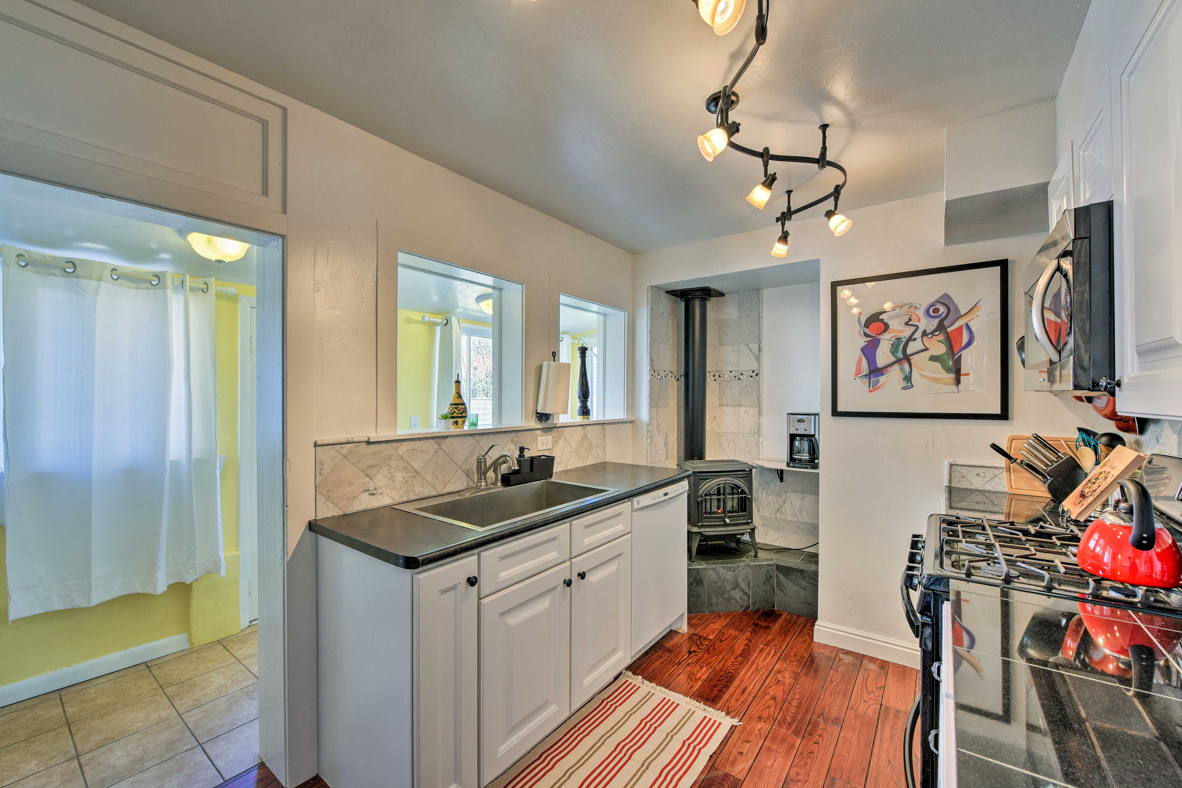 The kitchen is fully equipped, boasting windows to the sunroom.
