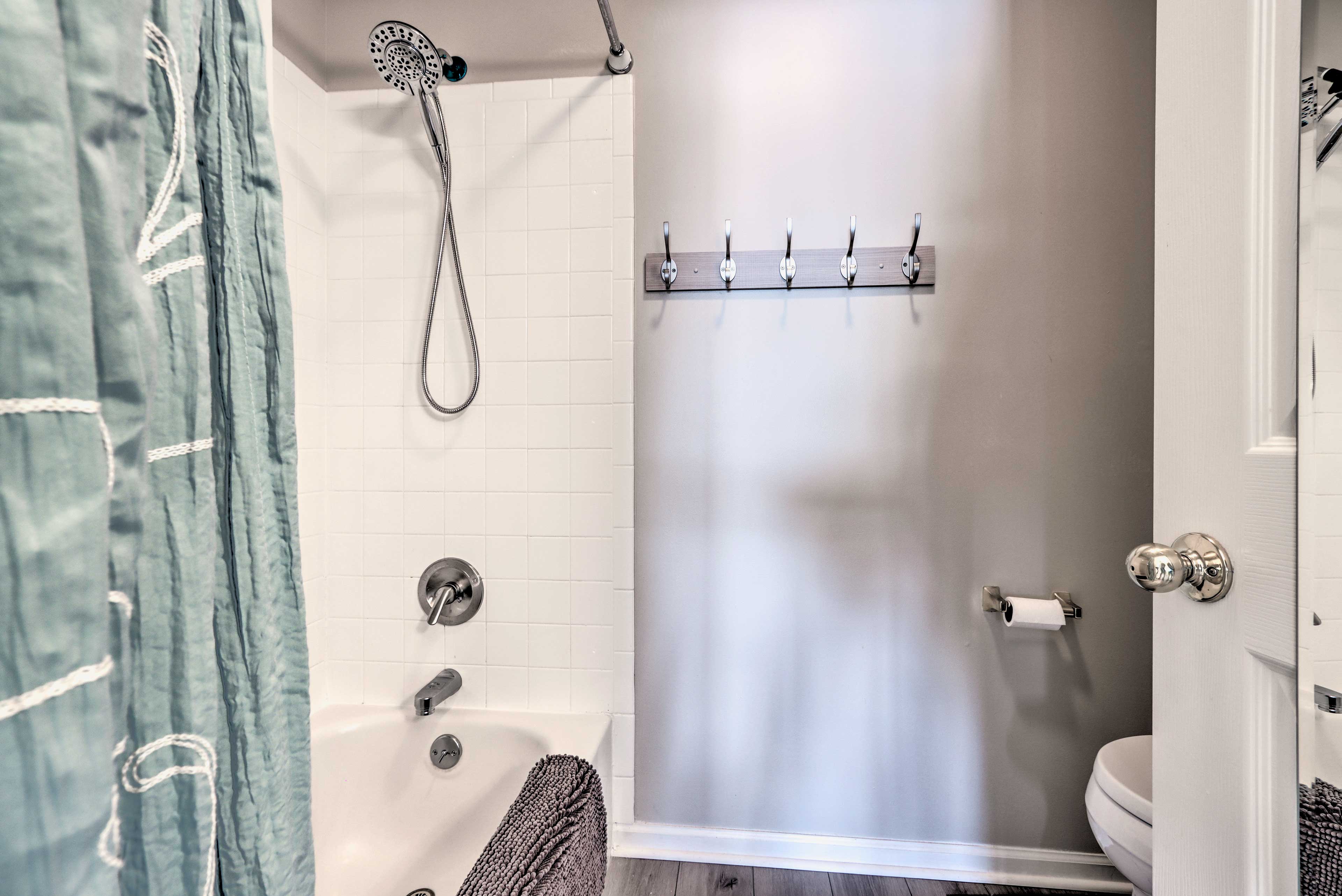 Rinse off in this tiled shower/tub combo.