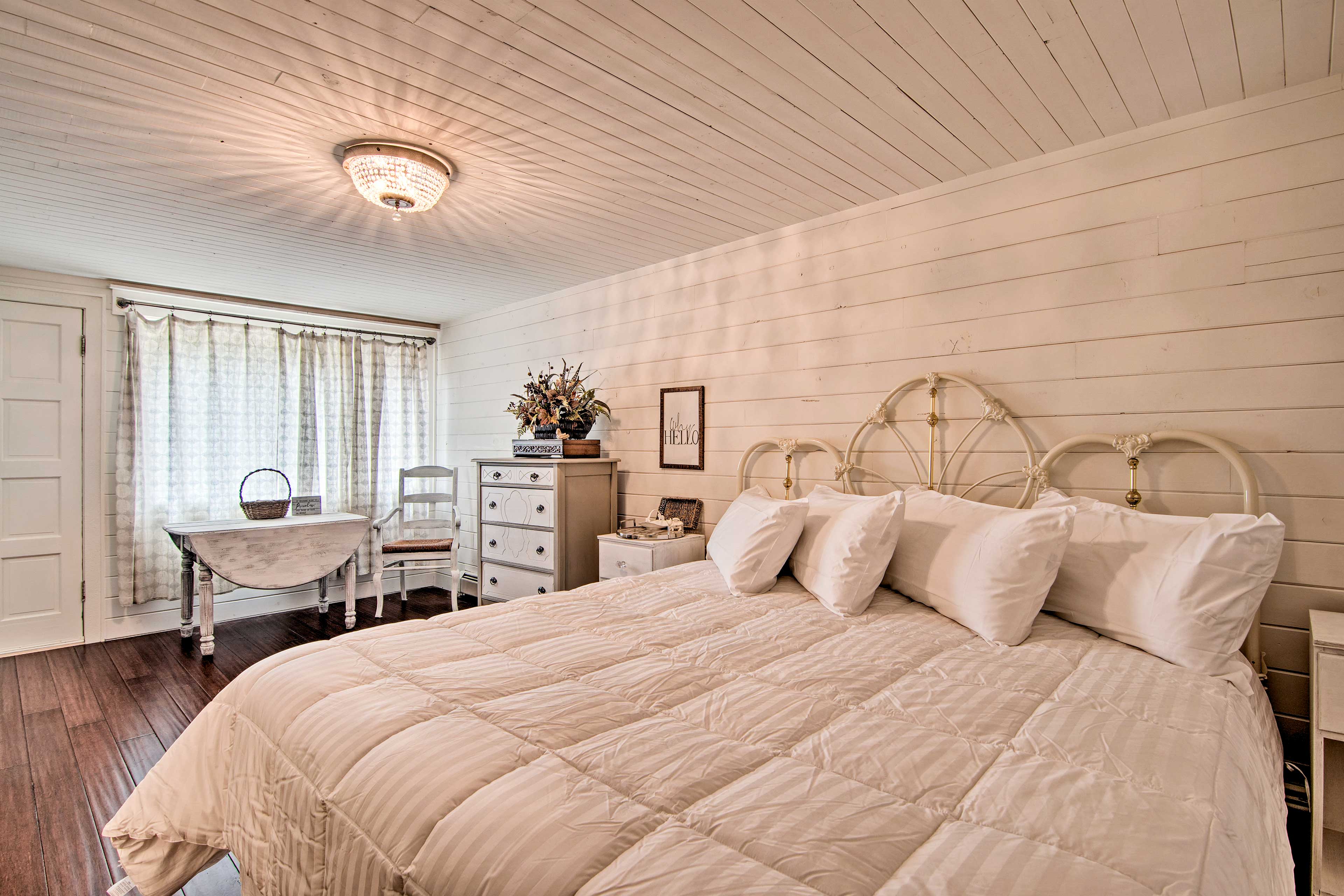 The room features a king bed and charming decor.