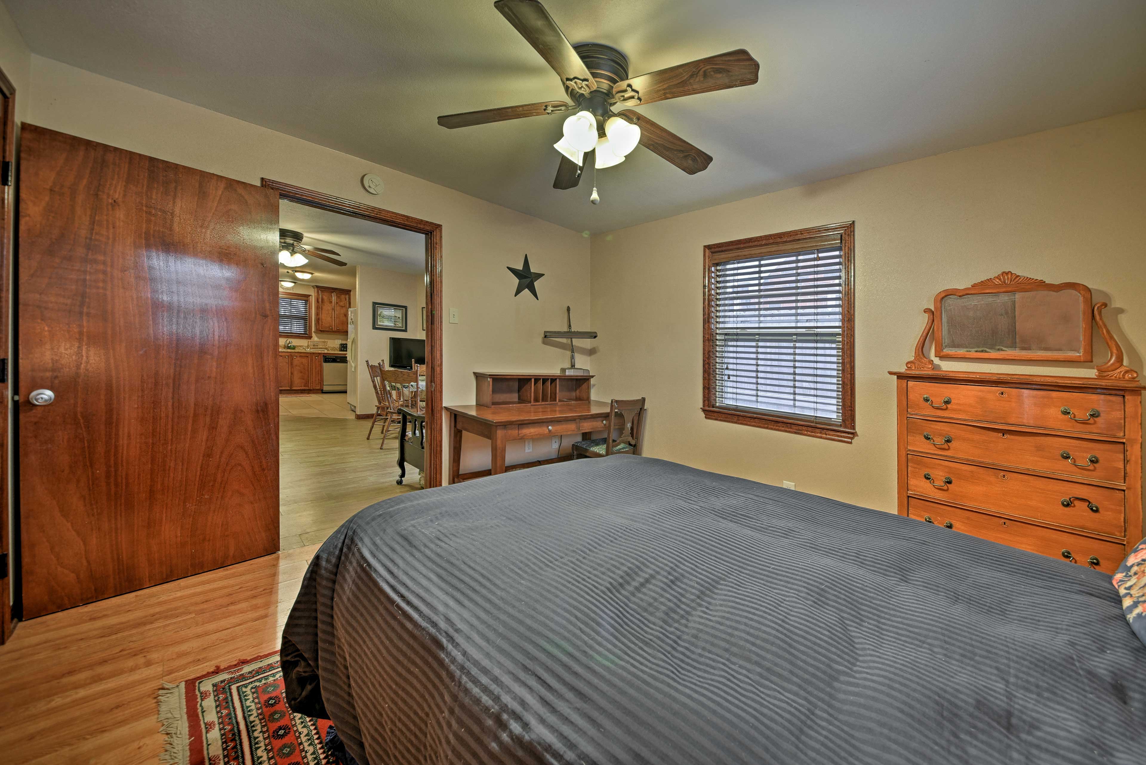 This bedroom boasts a queen bed and is steps from the living room.