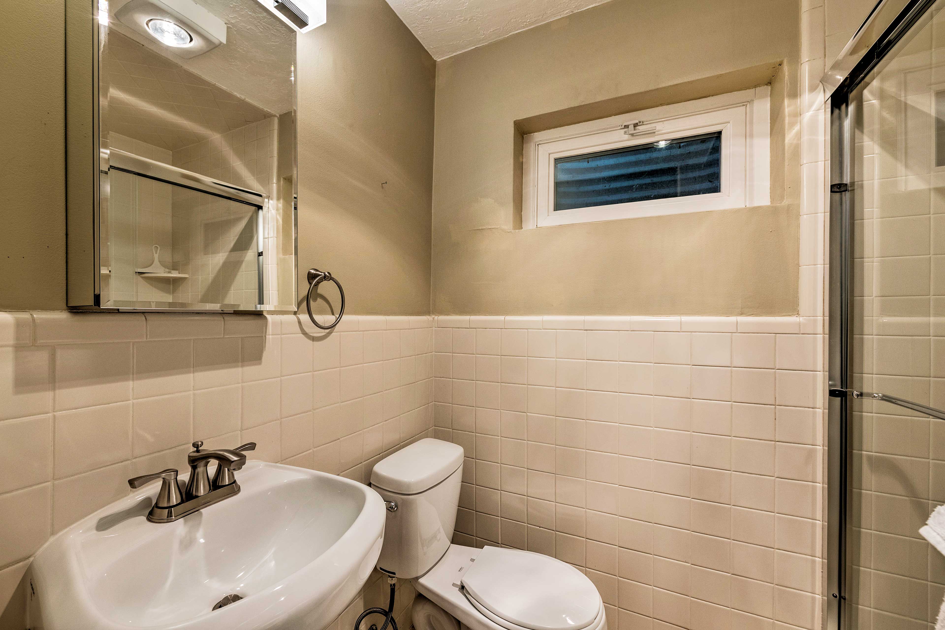 This full bathroom hosts a single vanity and walk-in shower.