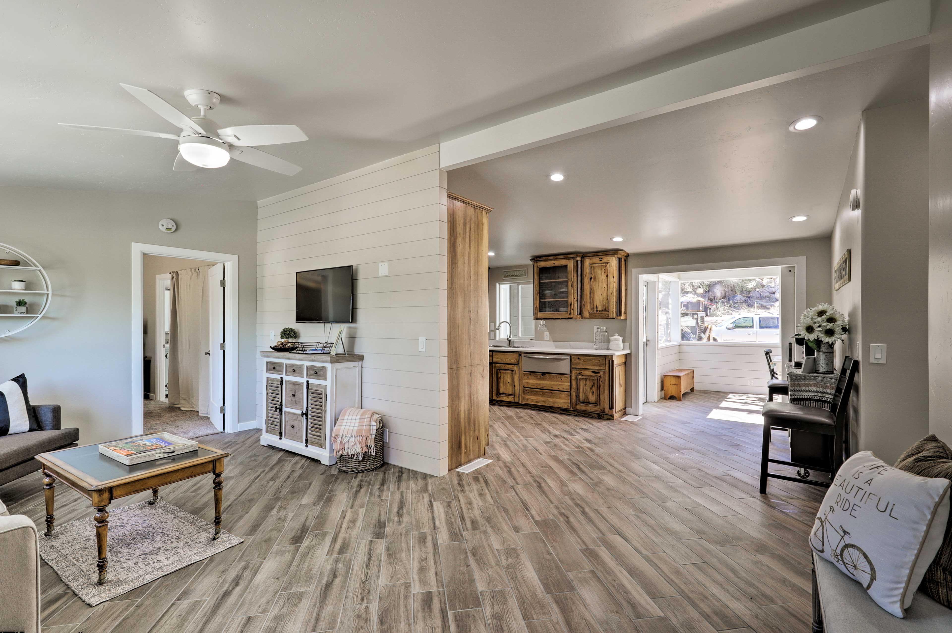 Hardwood floors connect the open living area & kitchen.