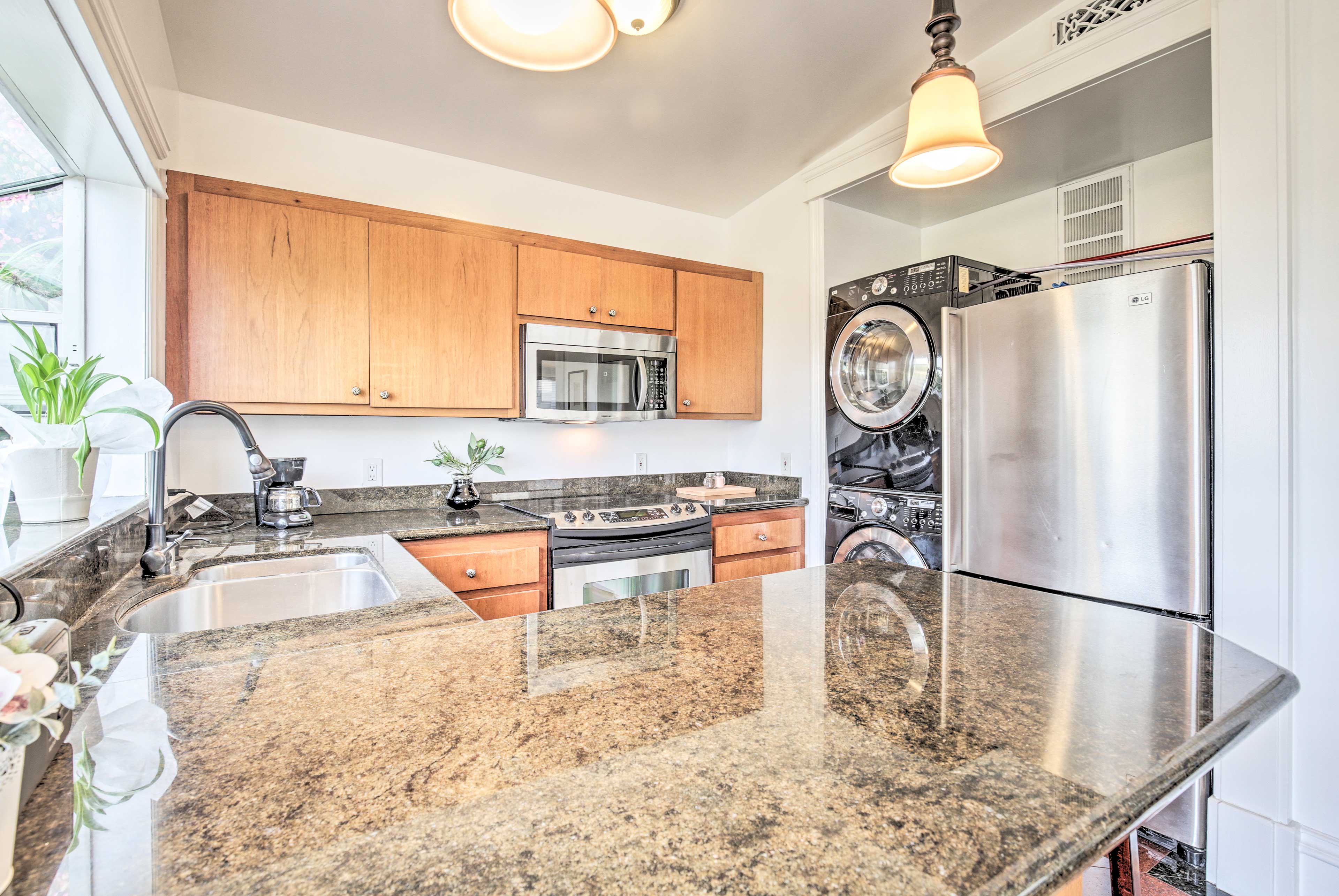 This kitchen is complete with granite countertops and stainless steel appliances