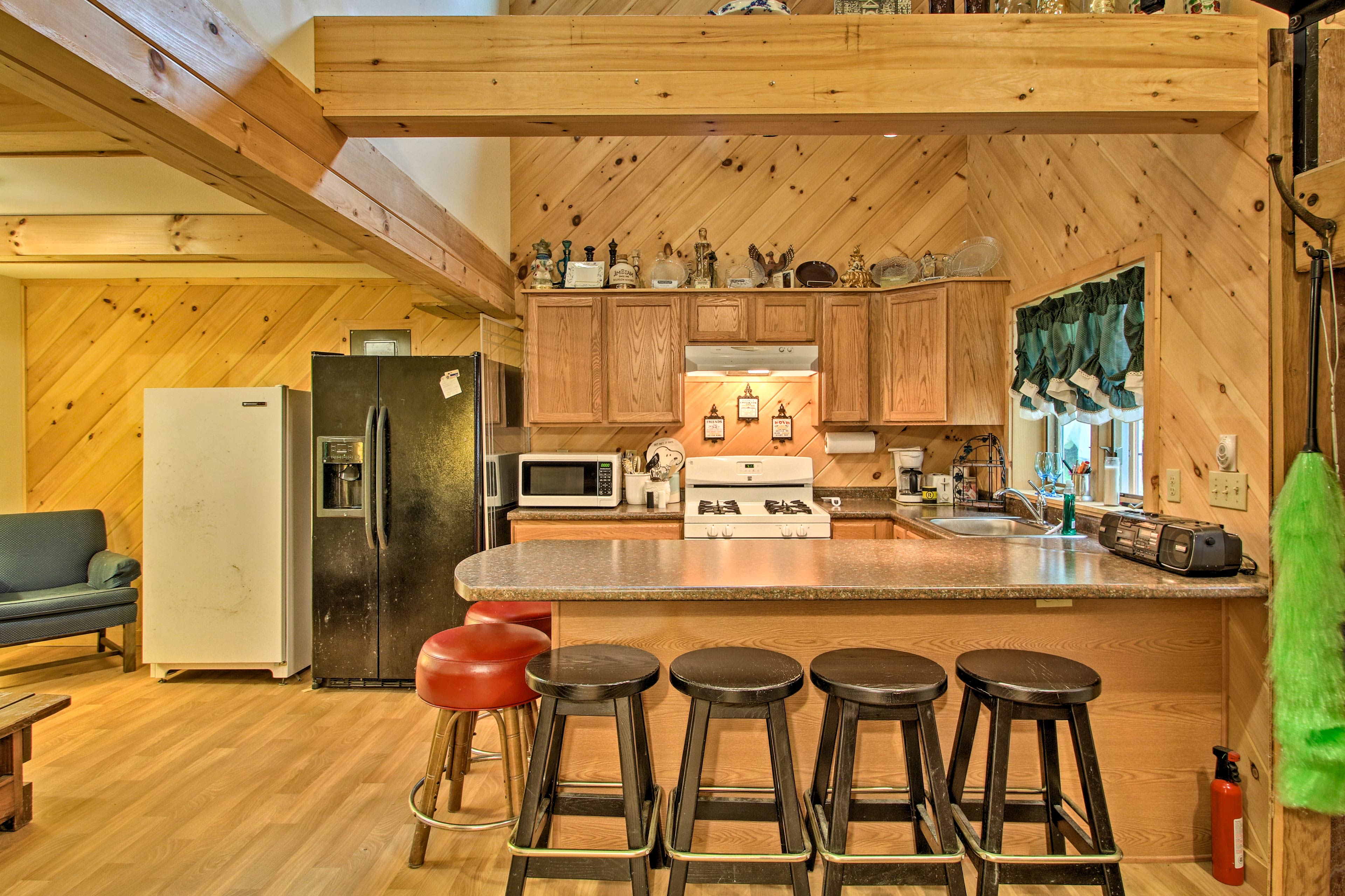 The 3-bedroom, 1-bathroom cabin features a well-equipped kitchen.