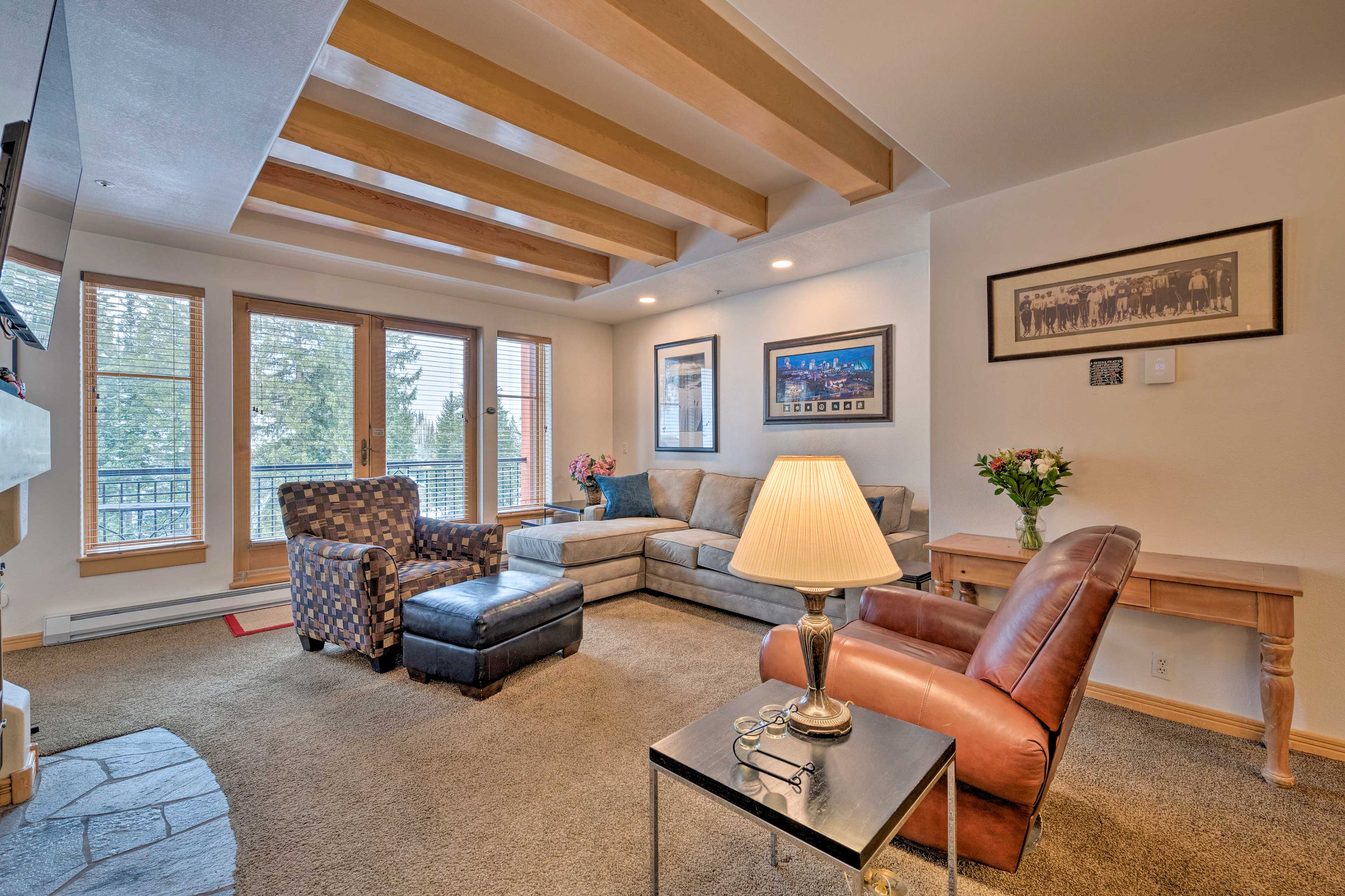 The living room features exposed wooden beams.