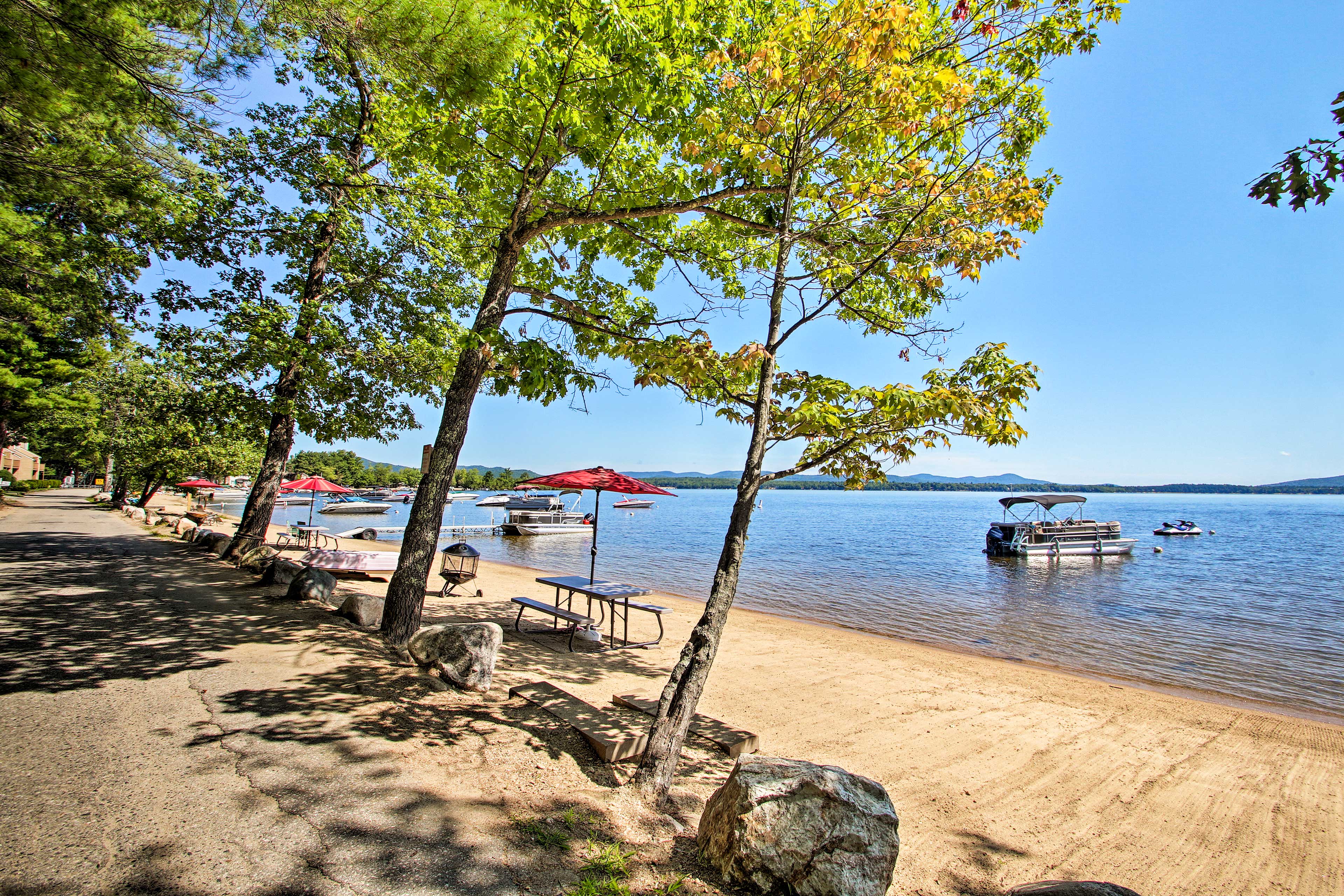 Walk along the beach while watching the waves from the boats.