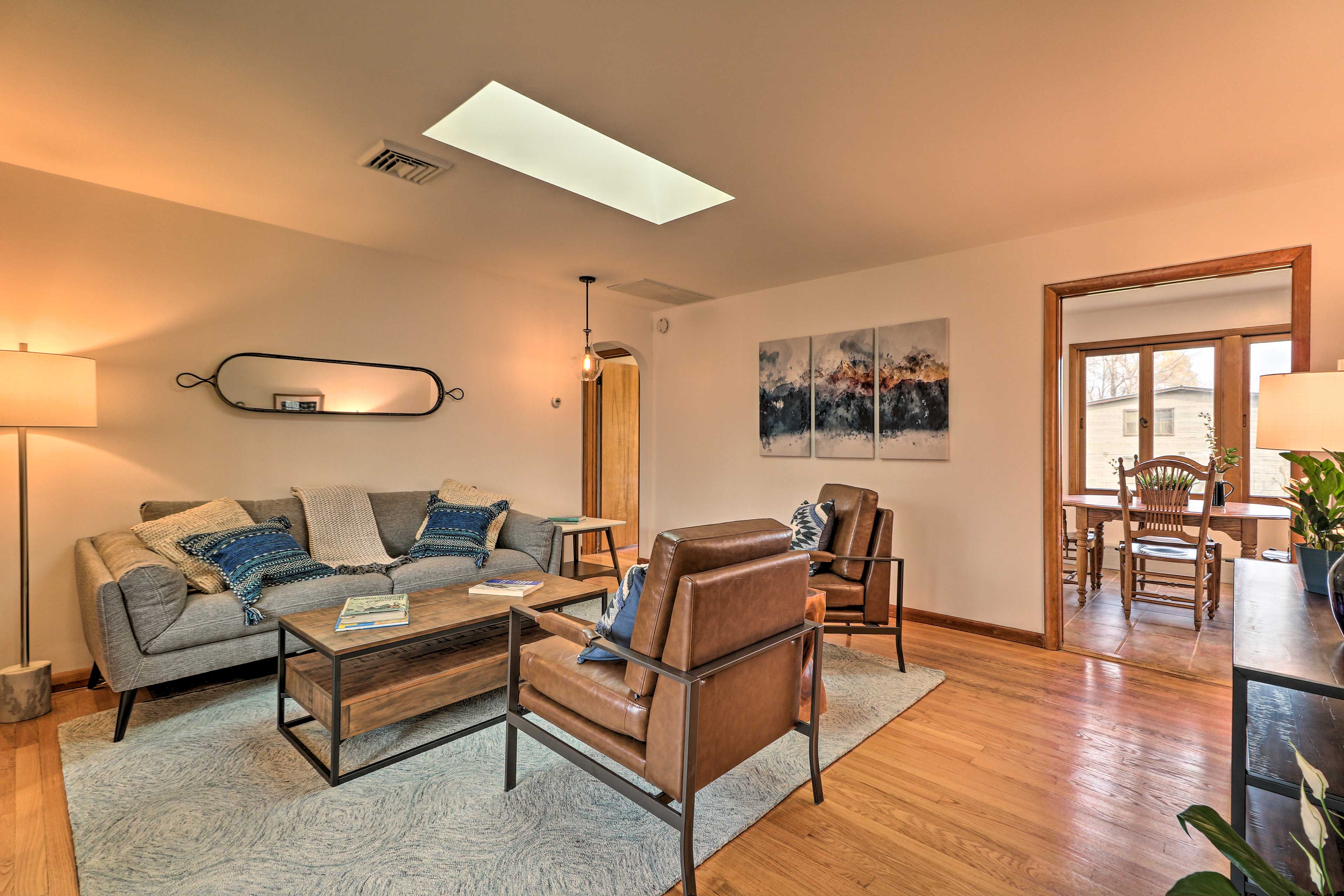 Gleaming hardwood floors reflect the sunlight streaming in.