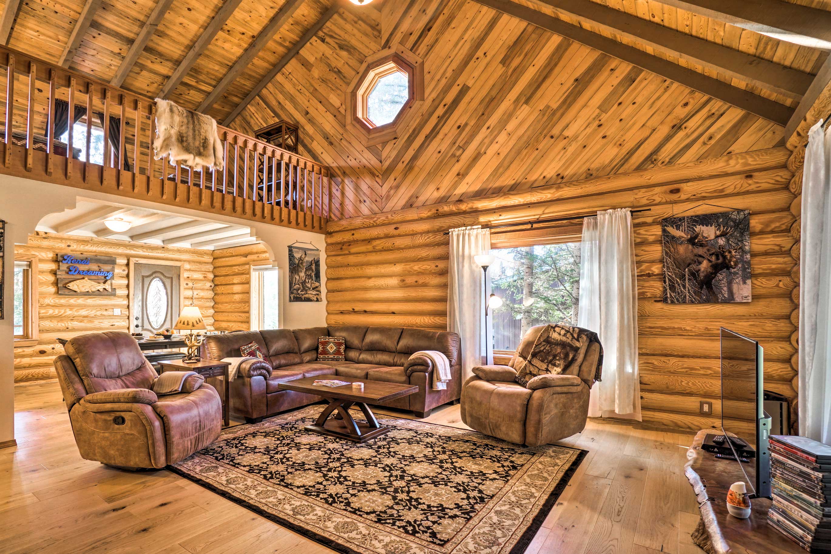 Inside, high vaulted ceilings frame the rustic living space.