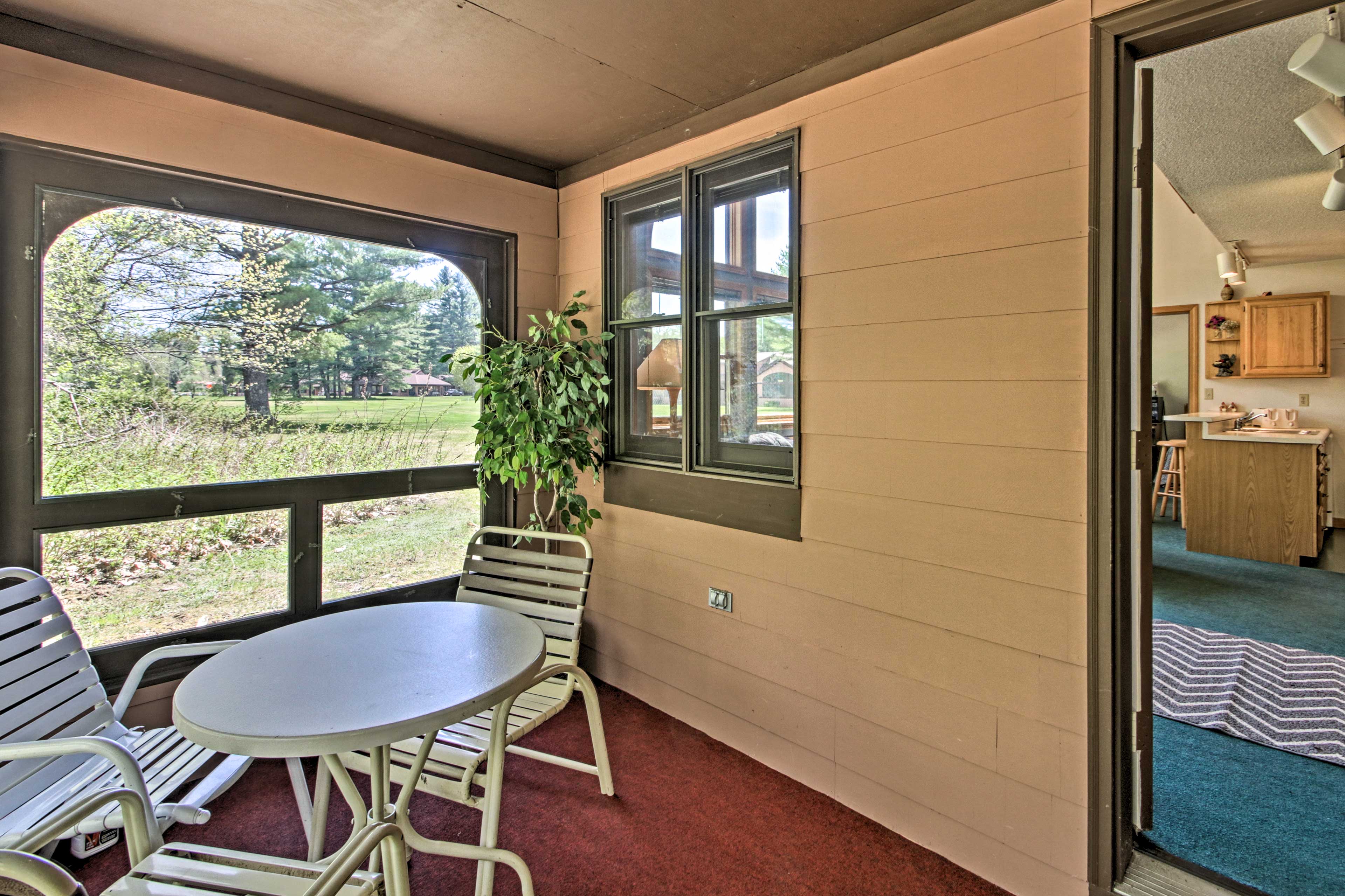 The patio features an outdoor dining table.