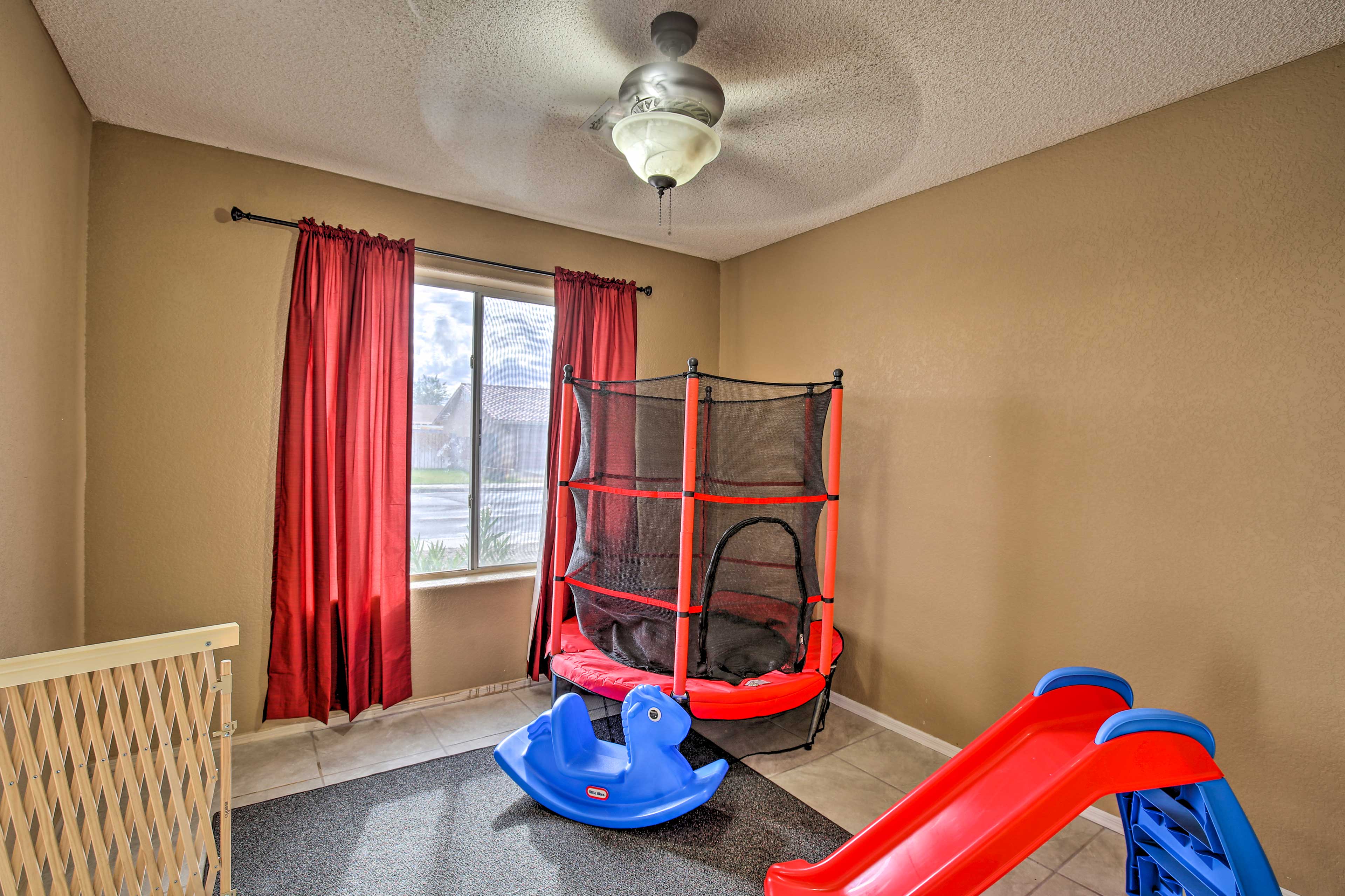 The play room offers a trampoline, slide and rocking horse.