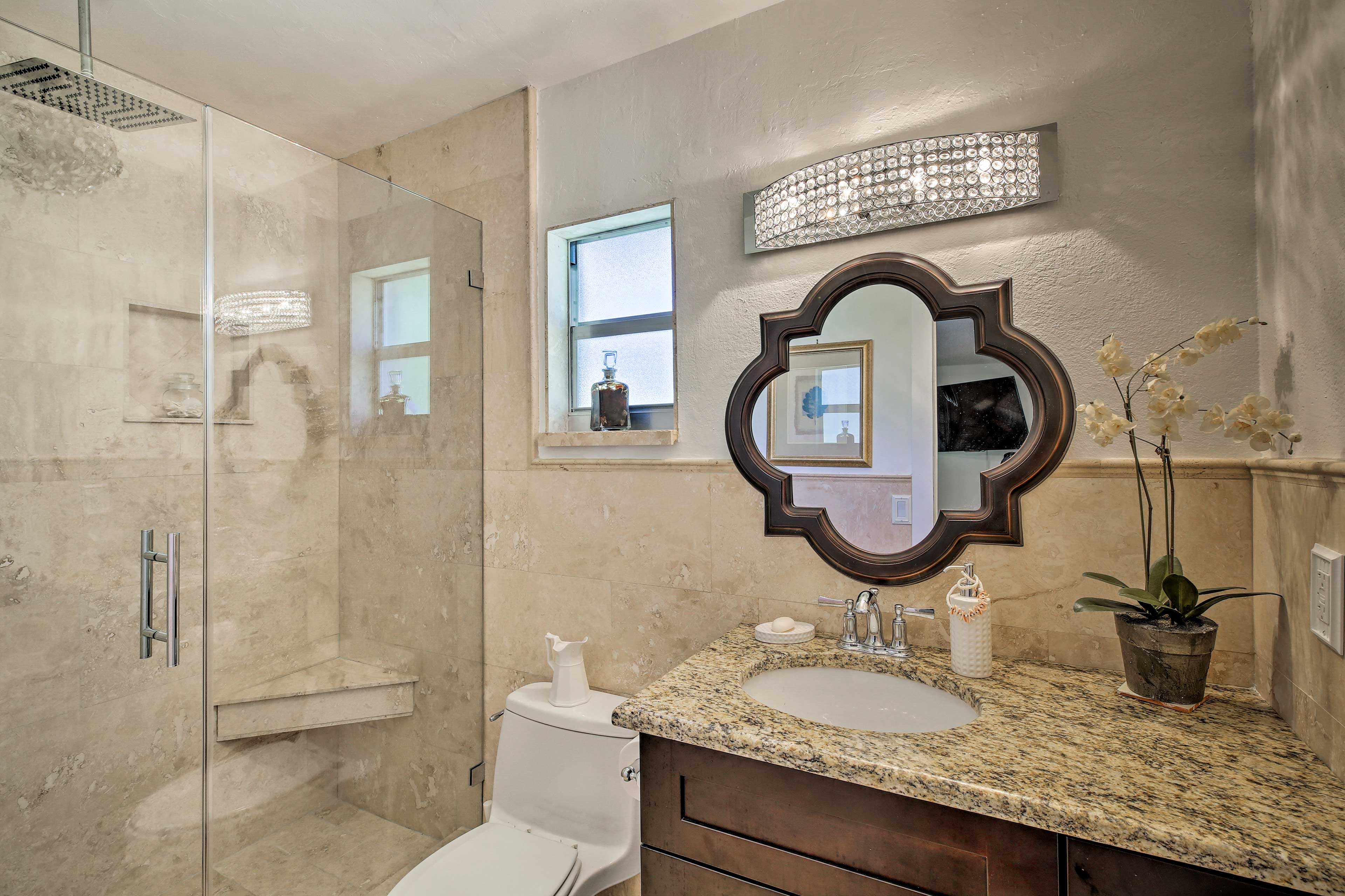 The en-suite bathroom is updated with a walk-in shower and sleek vanity.