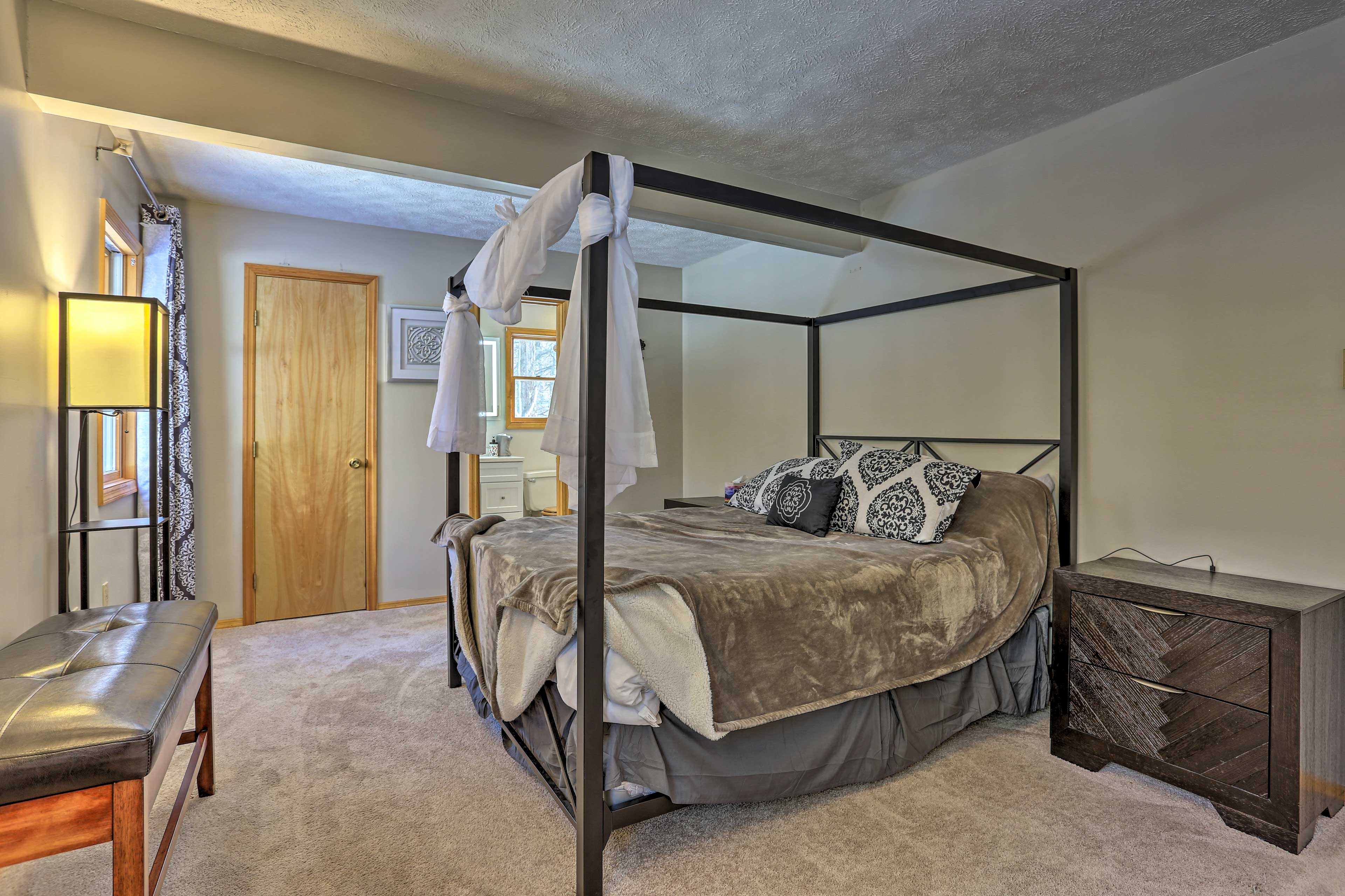 This bedroom boasts a 4-poster queen bed fit for 2.