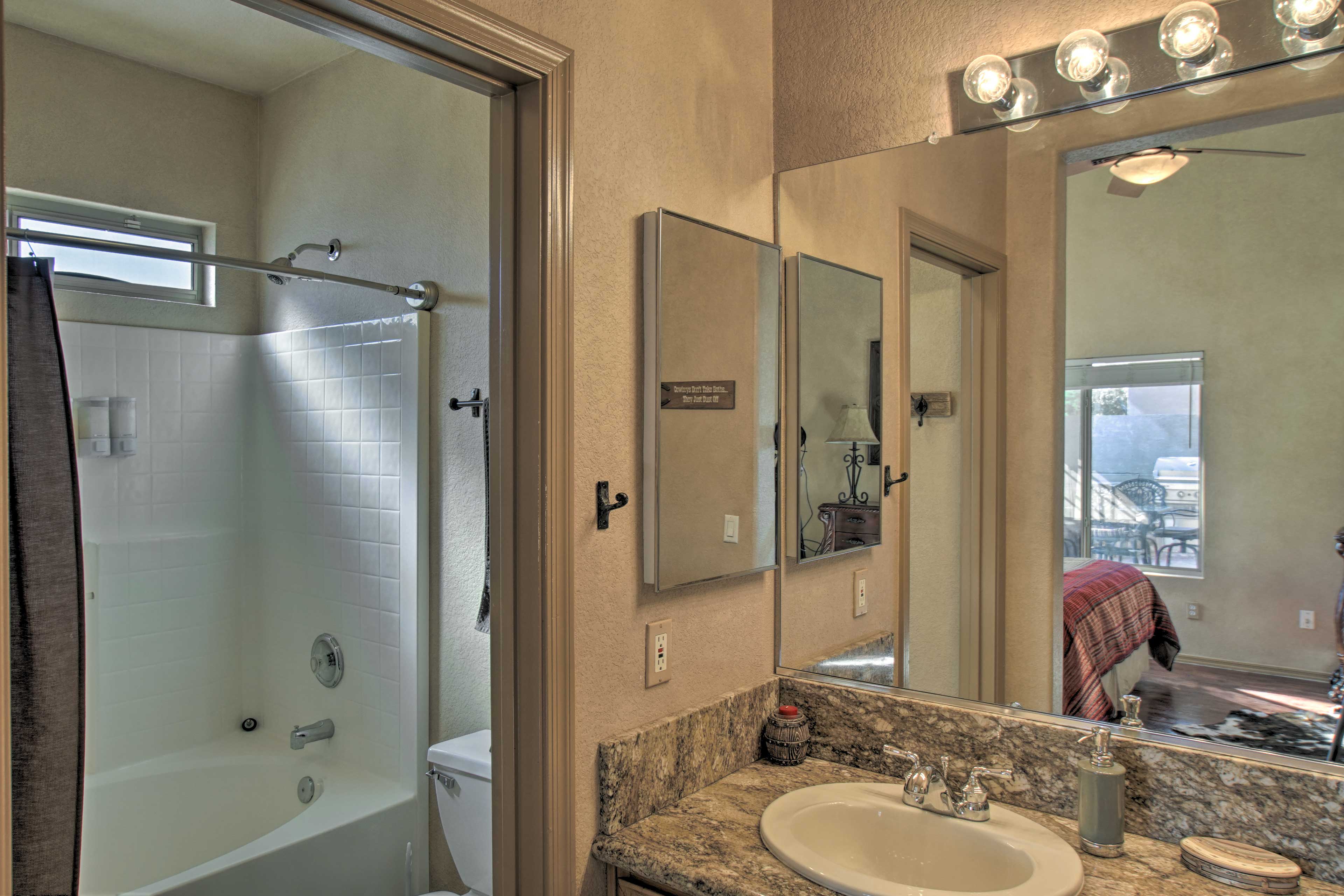 An en-suite bathroom is complete with a shower/tub combo.