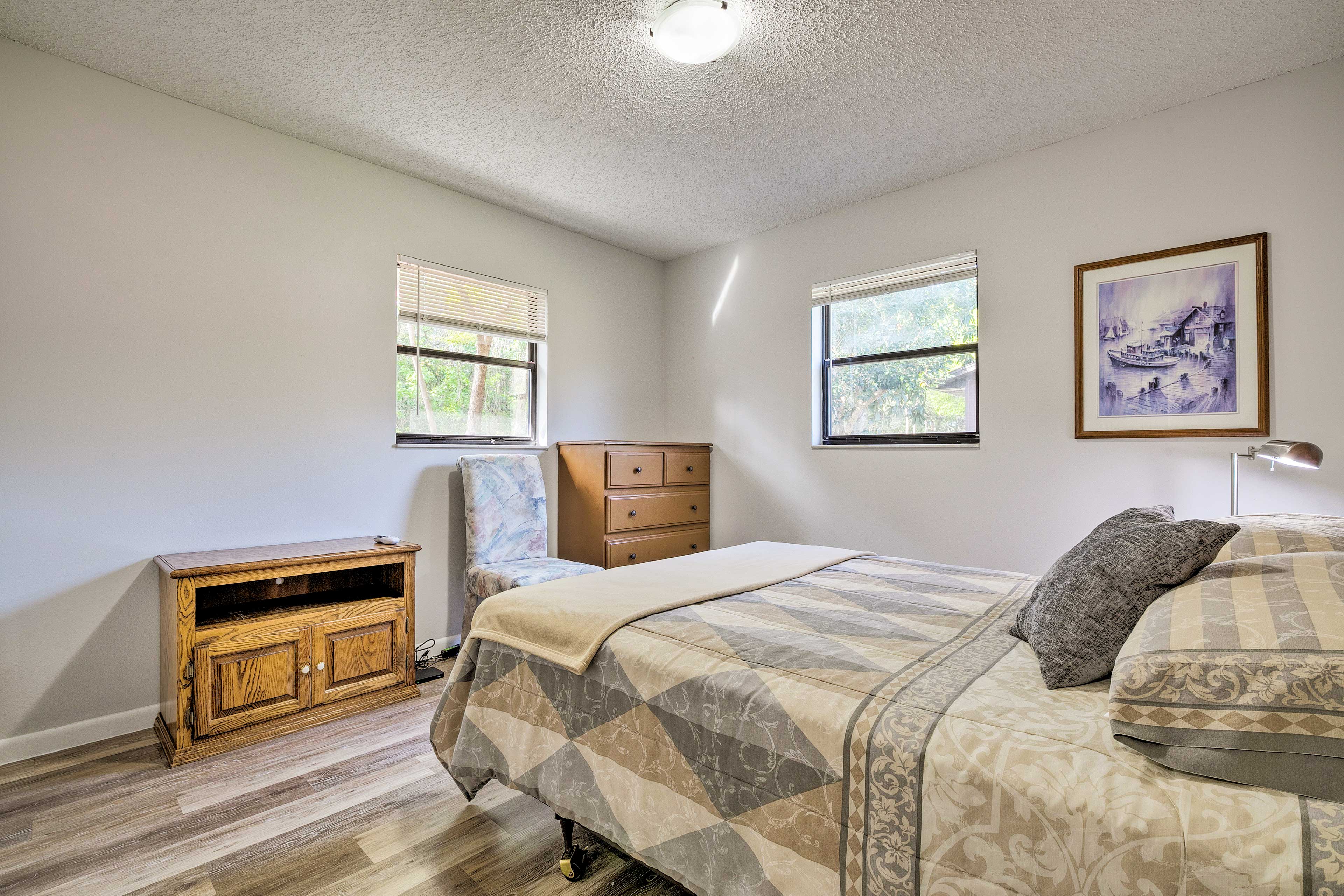 Bedroom 2 includes a dresser and queen bed.