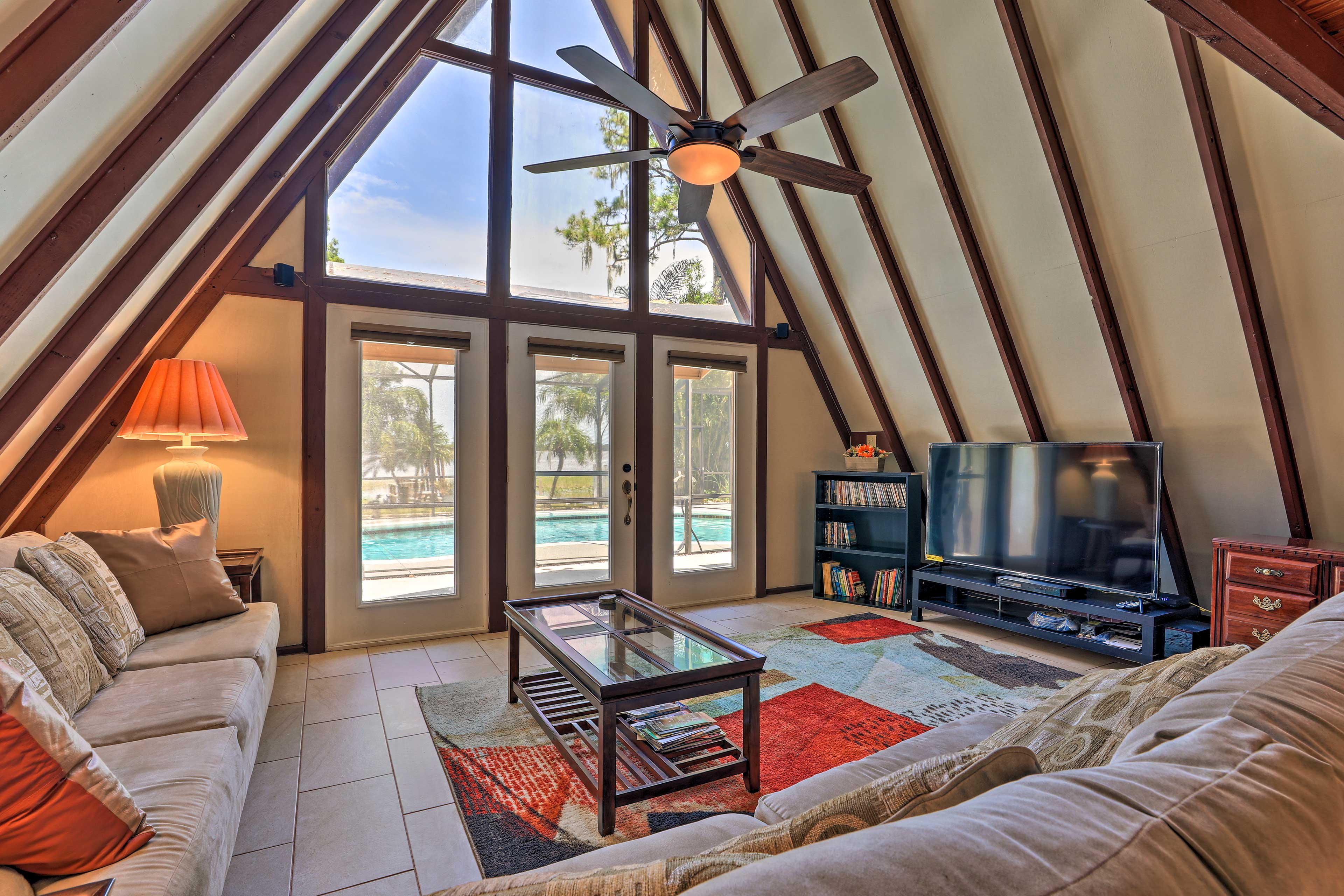 This home has a unique A-frame architecture and floor-to-ceiling windows.