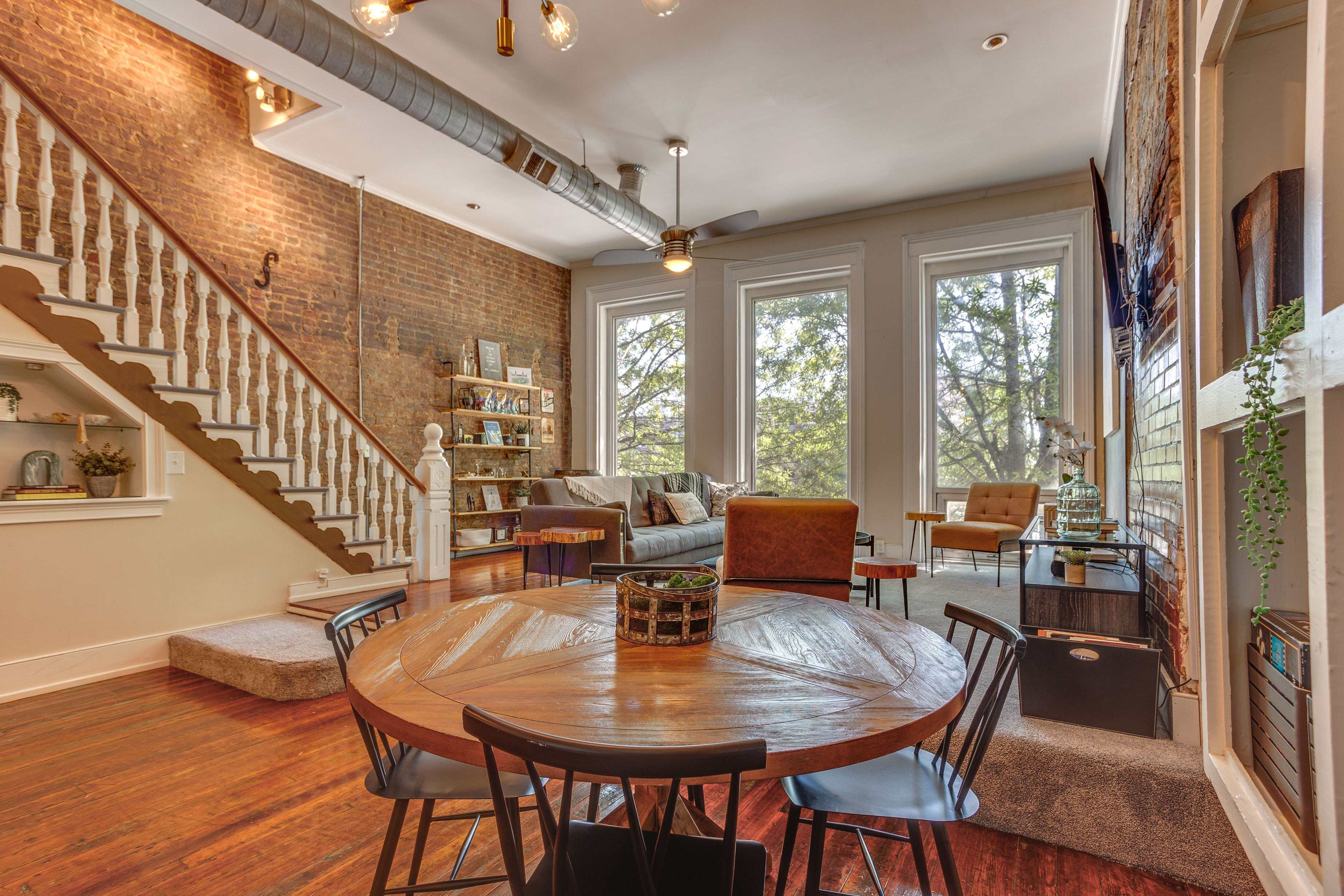 Dining Area | Exposed Brick | Hardwood Floors | Large Windows | Main Level