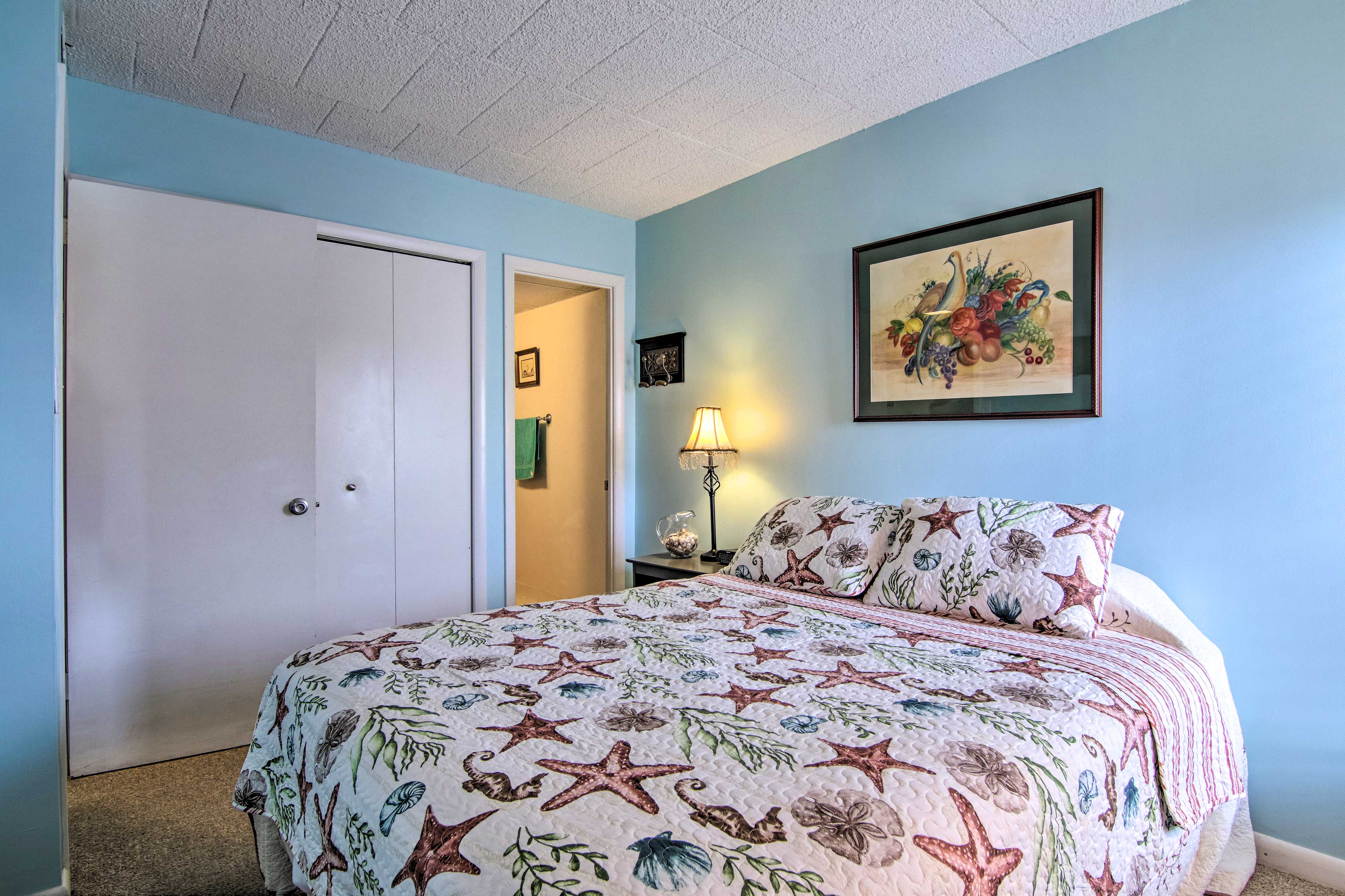 This room features a queen bed and coastal quilt.
