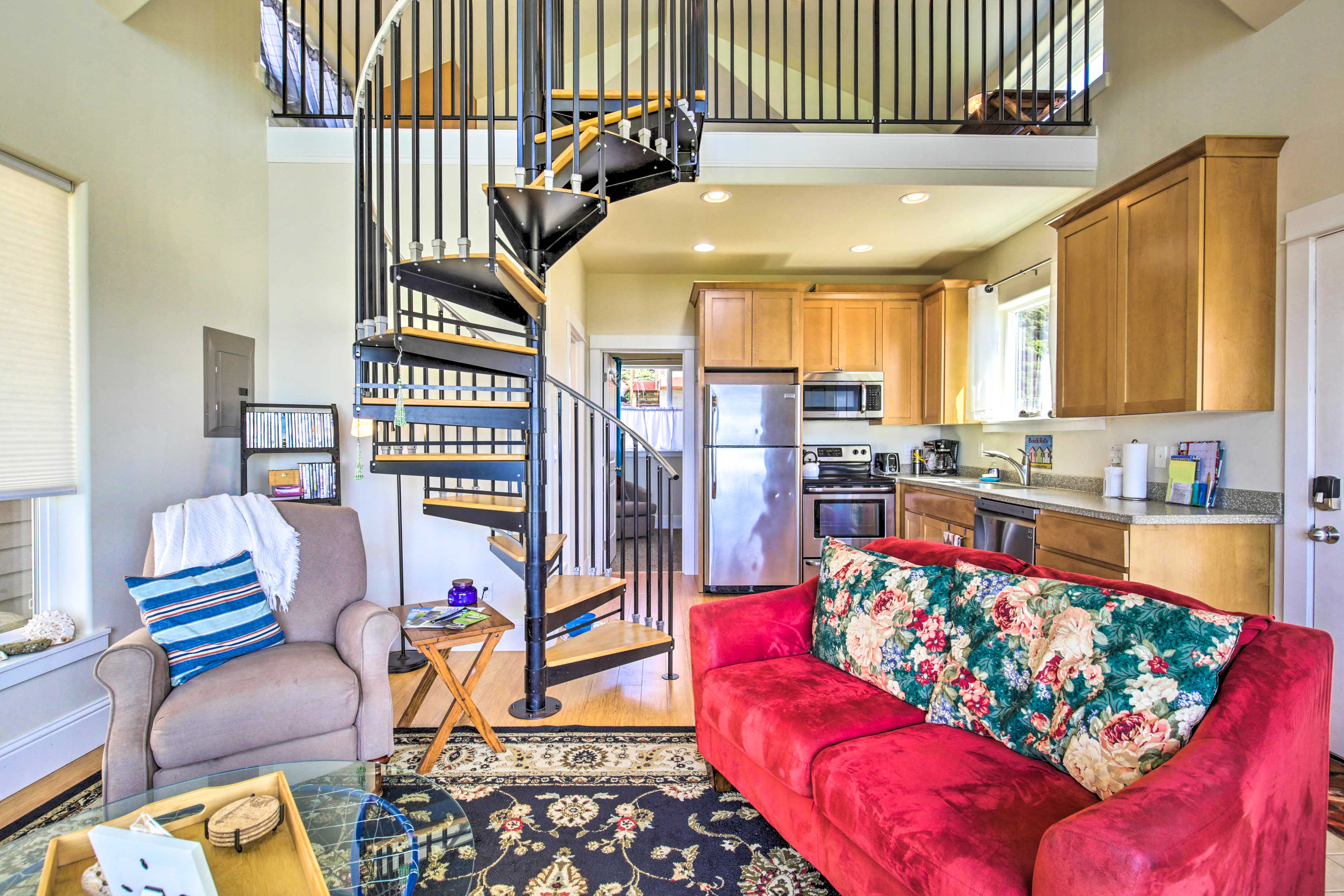 A spiral staircase leads to the second-level loft.