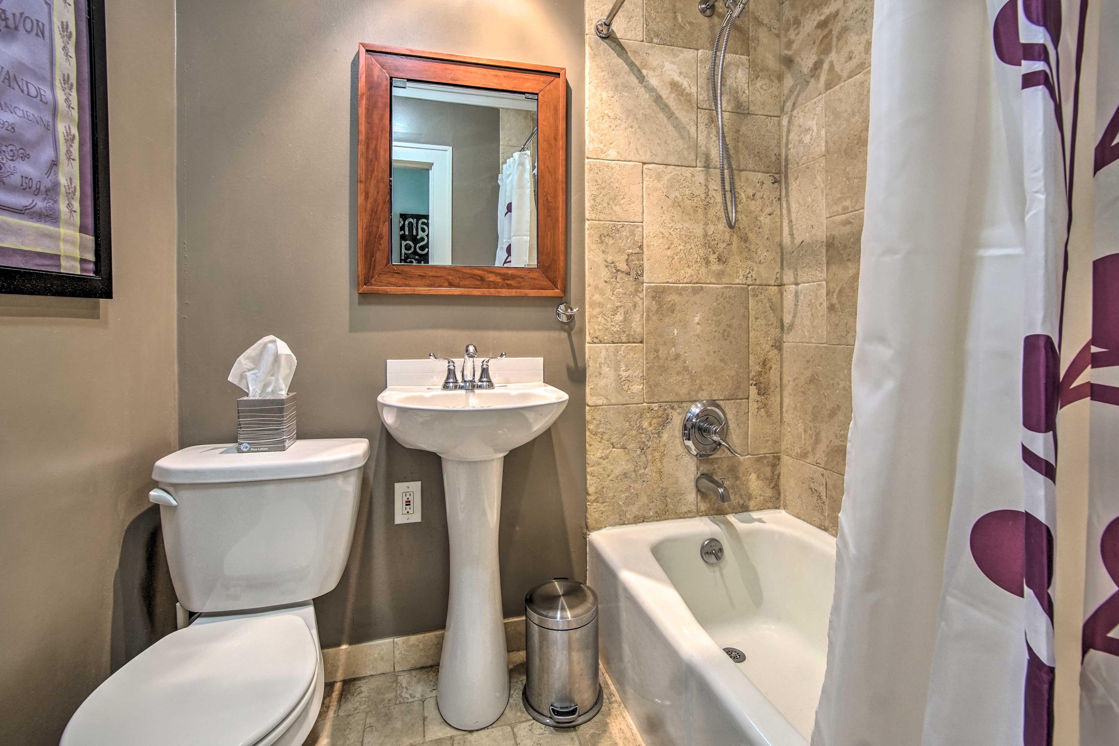 The full bathroom includes a shower/tub combo and a pedestal sink.