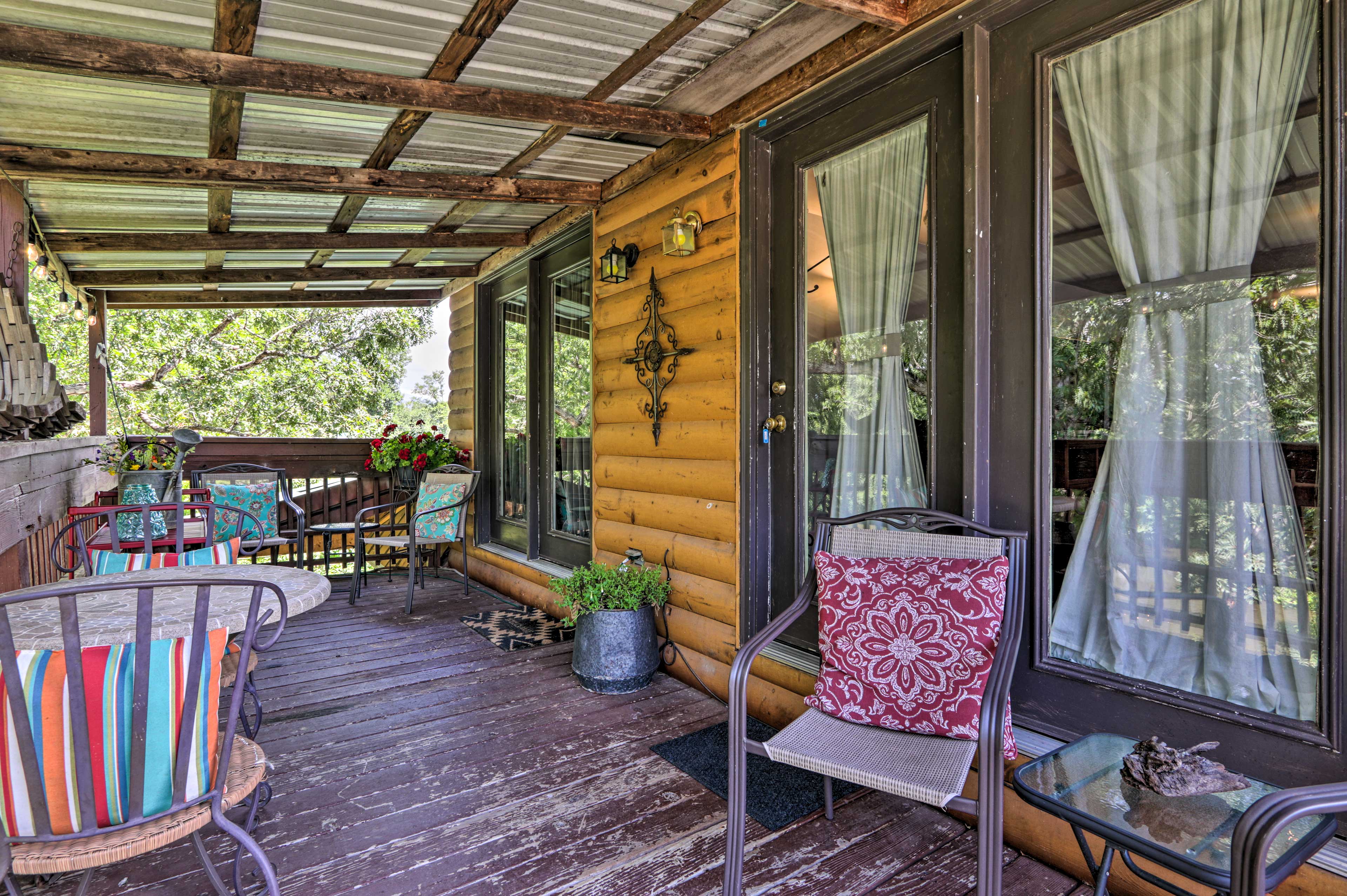 Embrace the fresh mountain air while sitting on the covered deck.