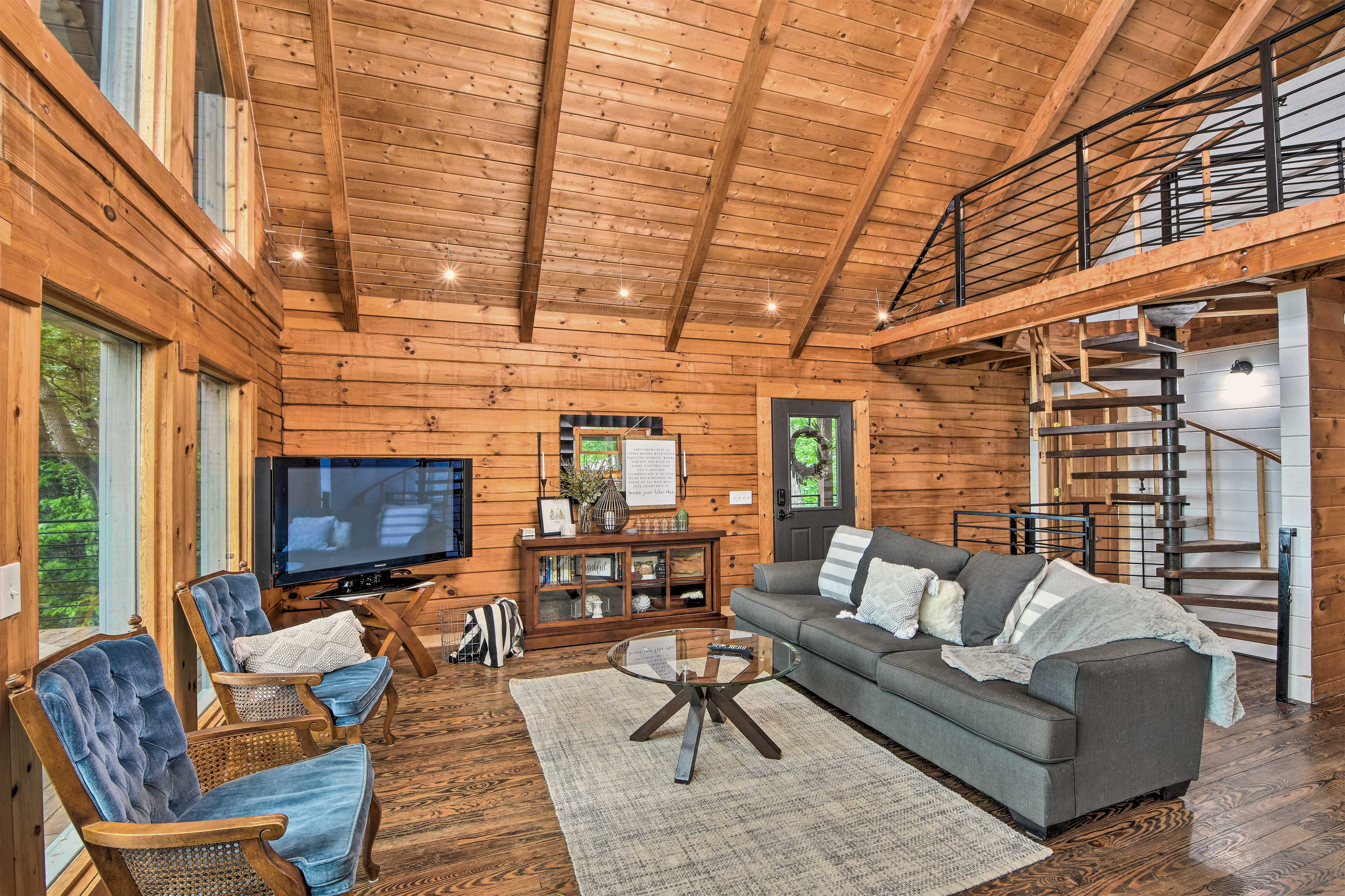 Living Room: Flat-screen Smart TV | Hardwood Floors | Large Windows