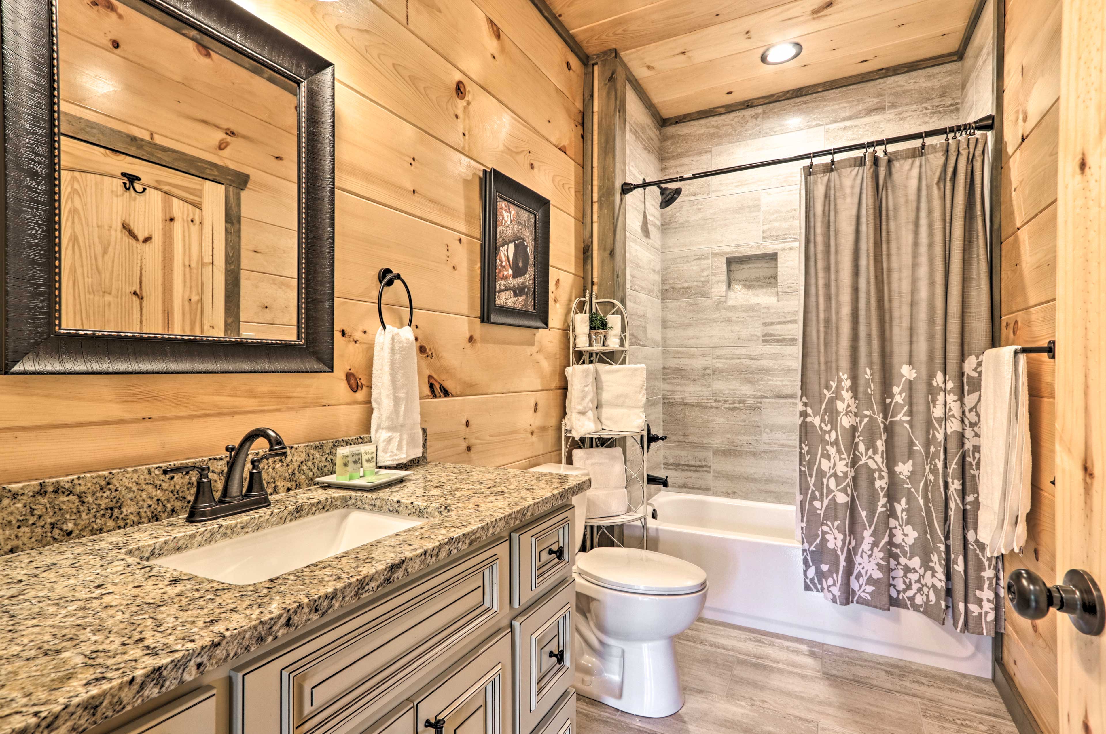 This bathroom boasts a shower/bathtub combo.